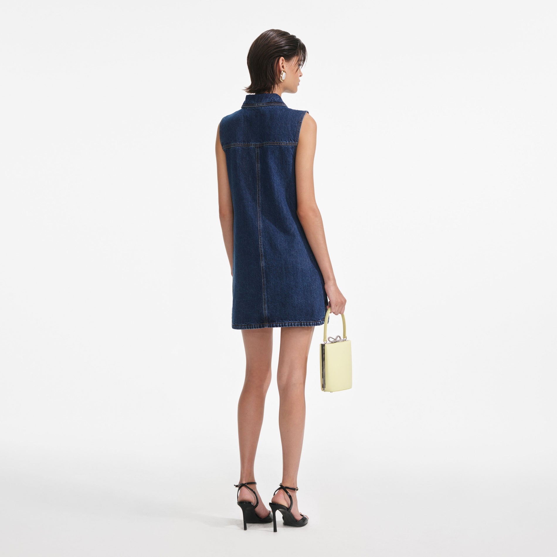 Back view of a woman wearing the Denim Sleeveless Mini Dress