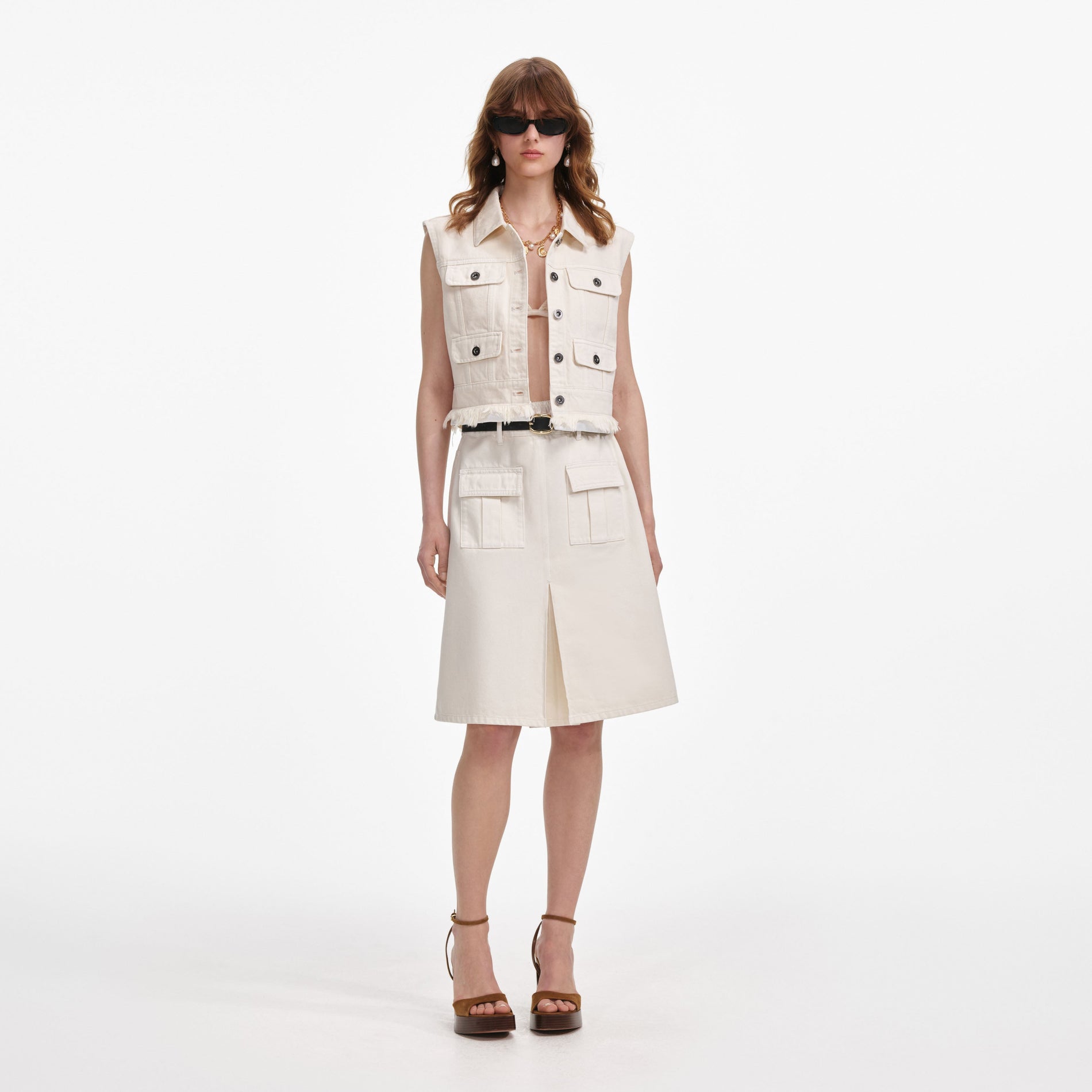 Front view of a woman wearing the Cream Denim Midi Skirt