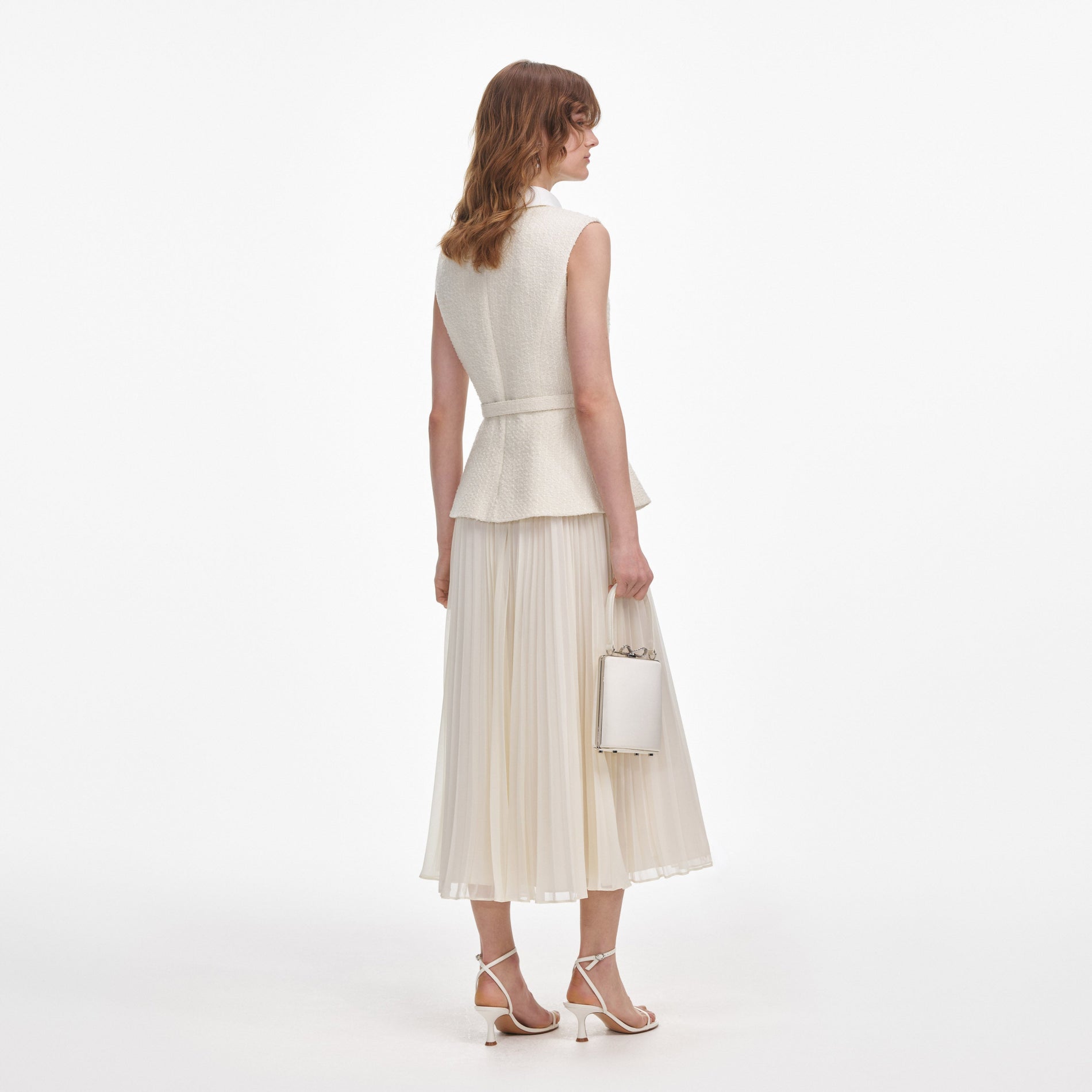 Back view of a woman wearing the Cream Boucle Sleeveless Midi Dress