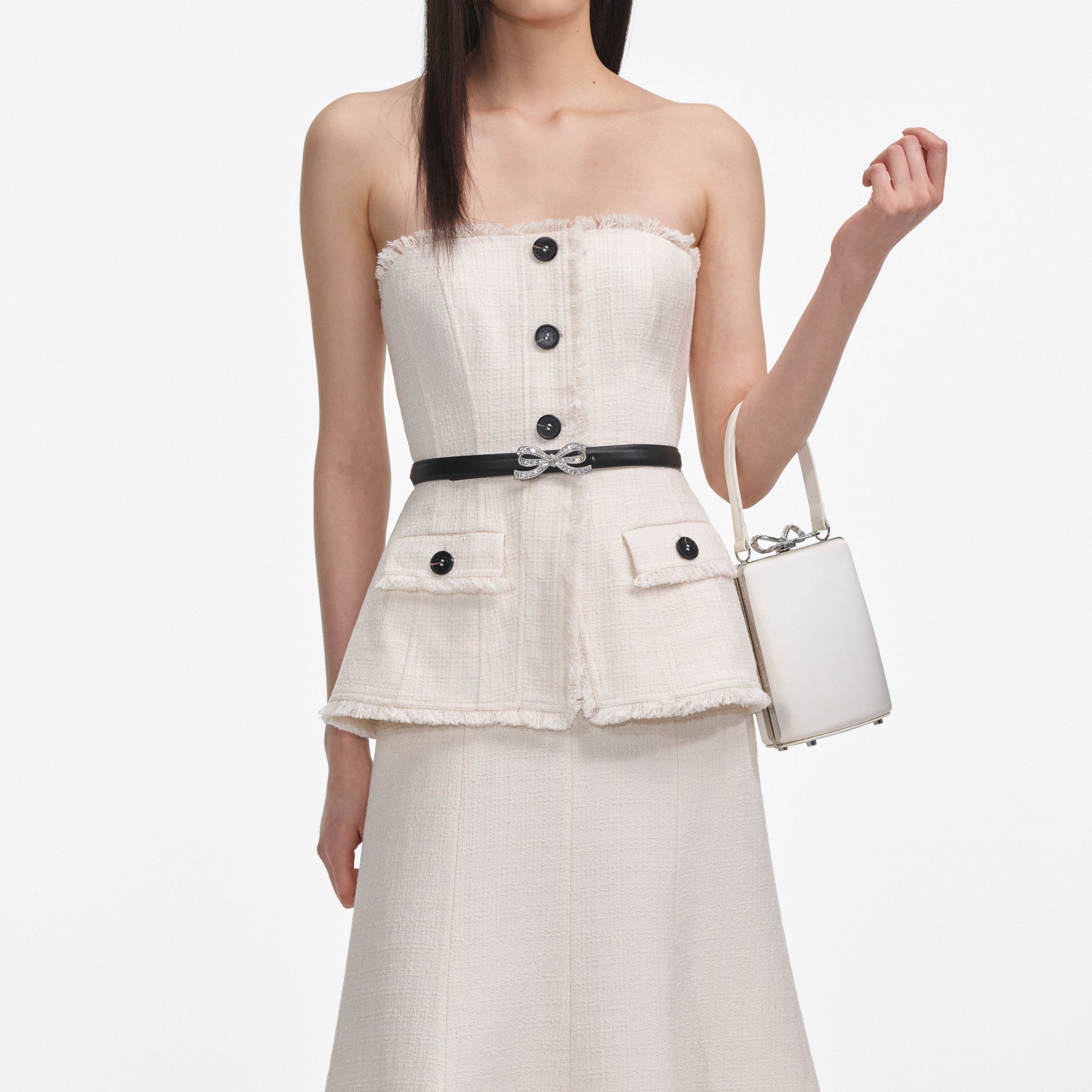 A close up of a woman wearing the Cream Boucle Bandeau Midi Dress