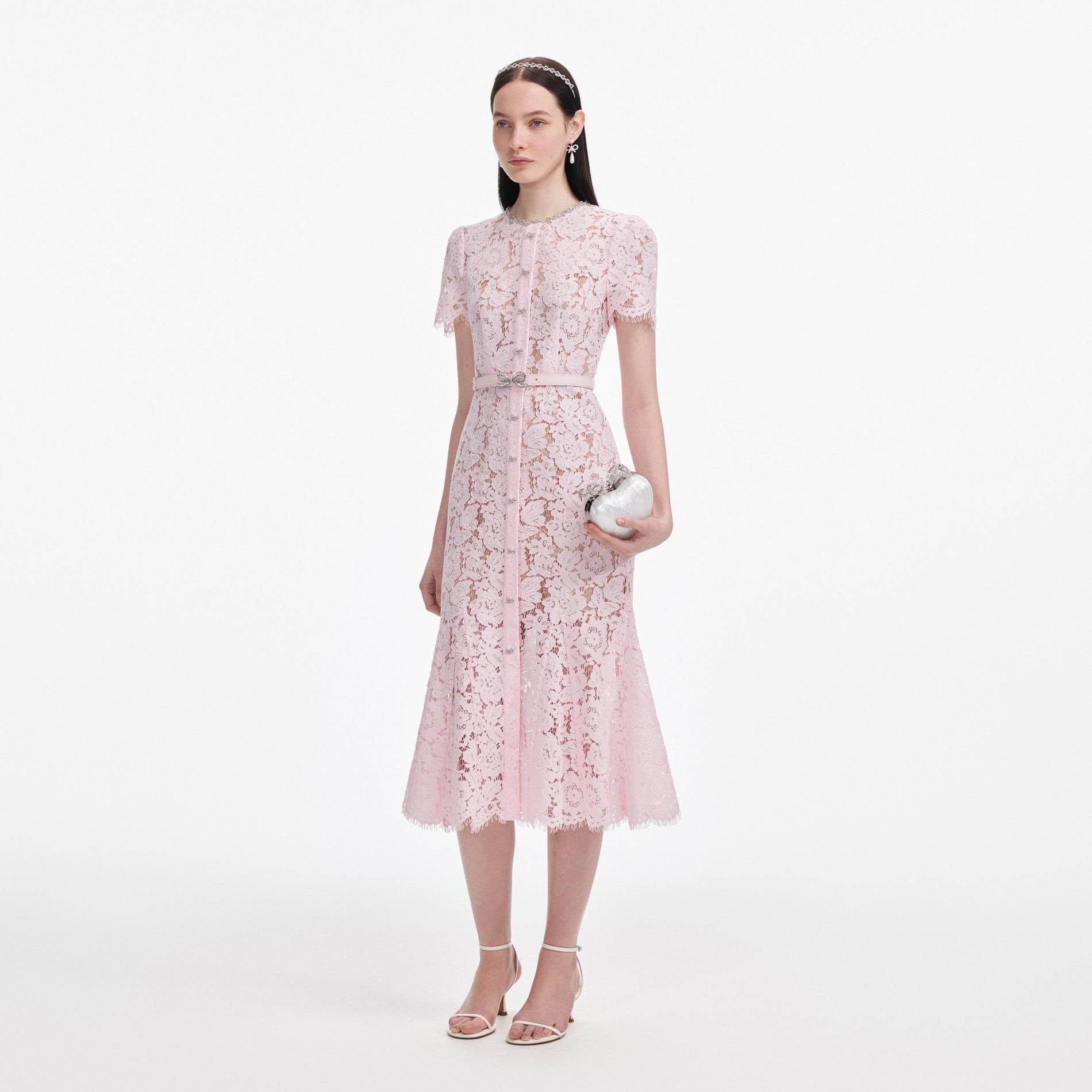 Side view of a woman wearing the Pink Lace Bow Trim Midi Dress