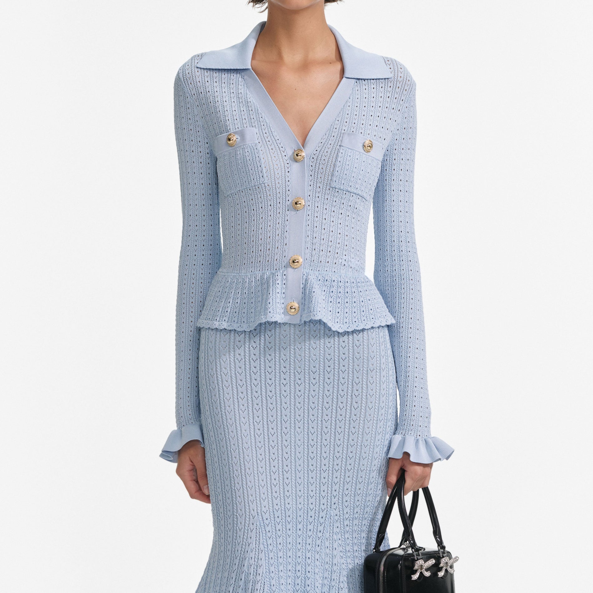 A close up of a woman wearing the Blue Pointelle Knit Midi Dress