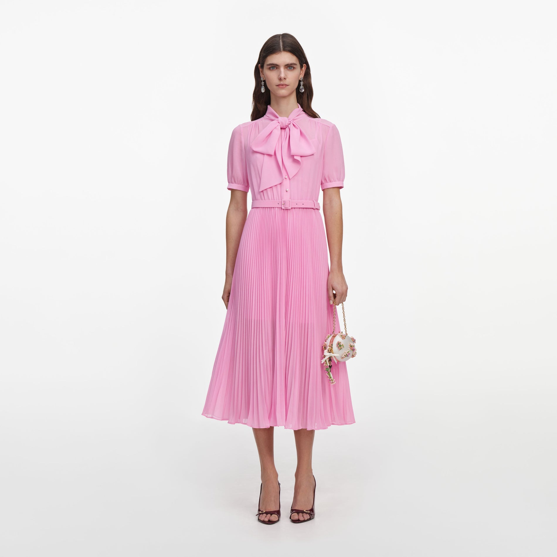 Front view of a woman wearing the Pink Georgette Tie Neck Midi Dress
