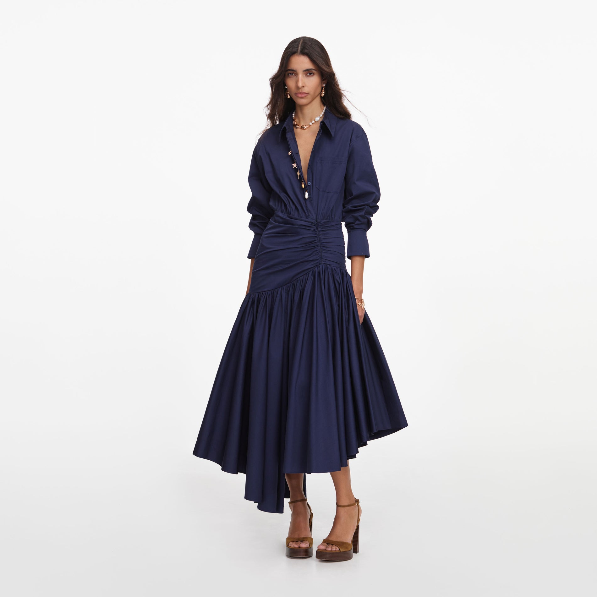 Side view of a woman wearing the Navy Cotton Asymmetric Midi Dress
