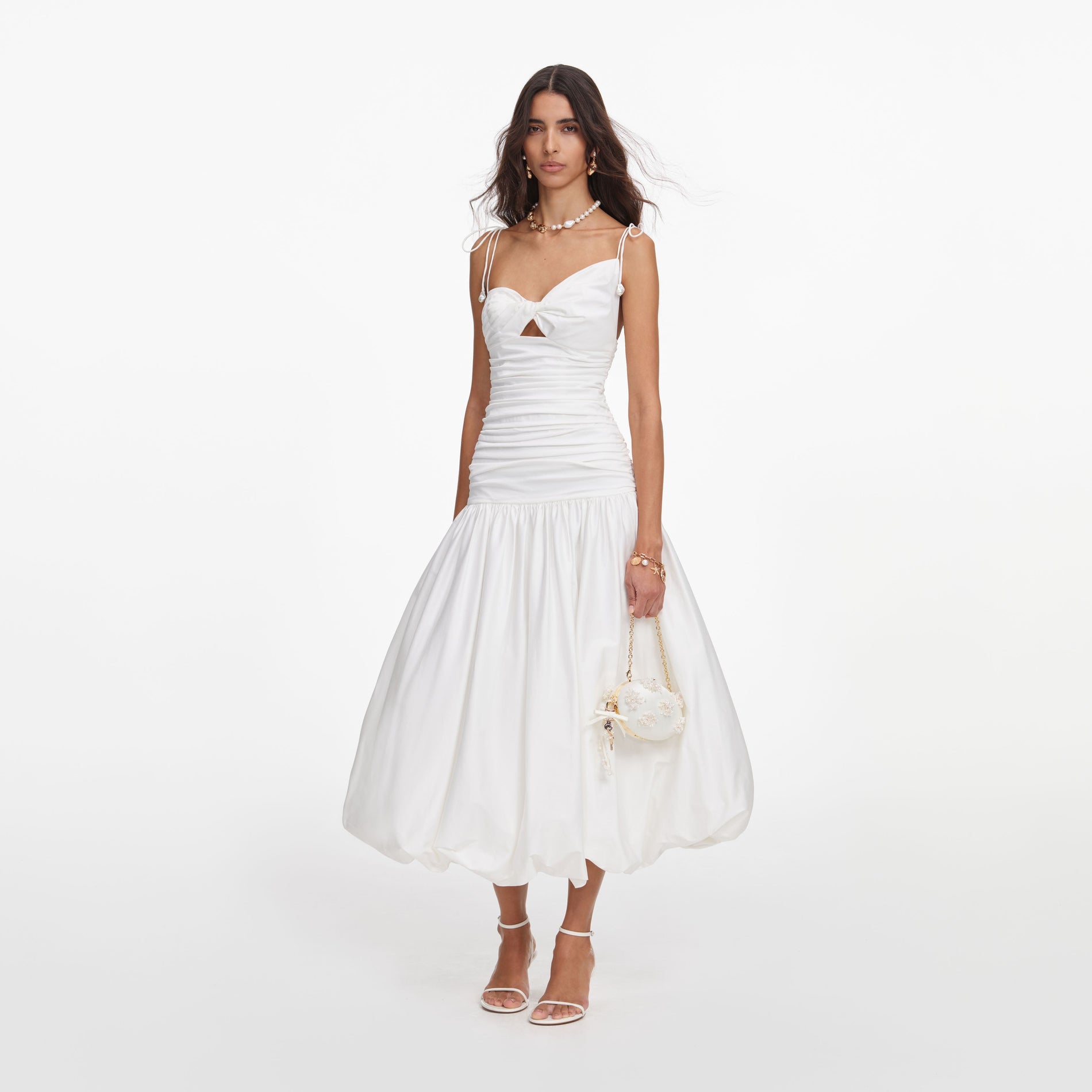 Side view of a woman wearing the White Cotton Gathered Midi Dress