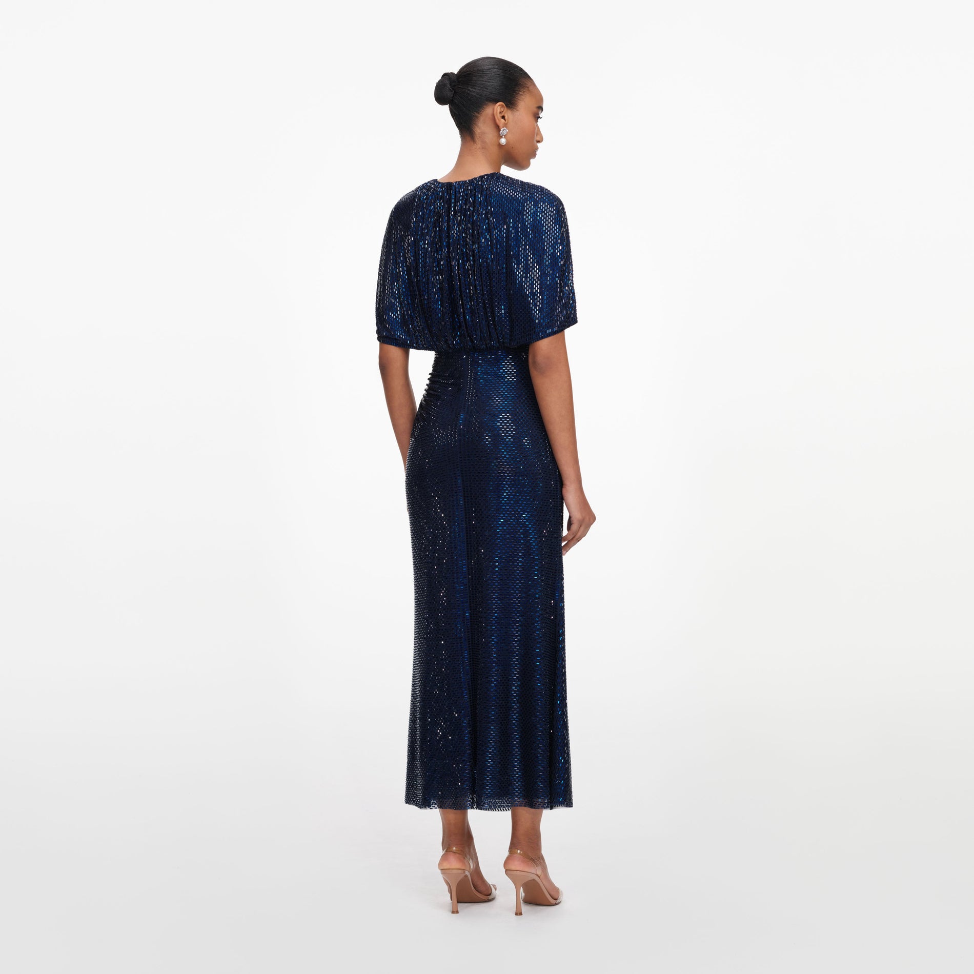 Back view of a woman wearing the Navy Rhinestone Cape Sleeve Midi Dress