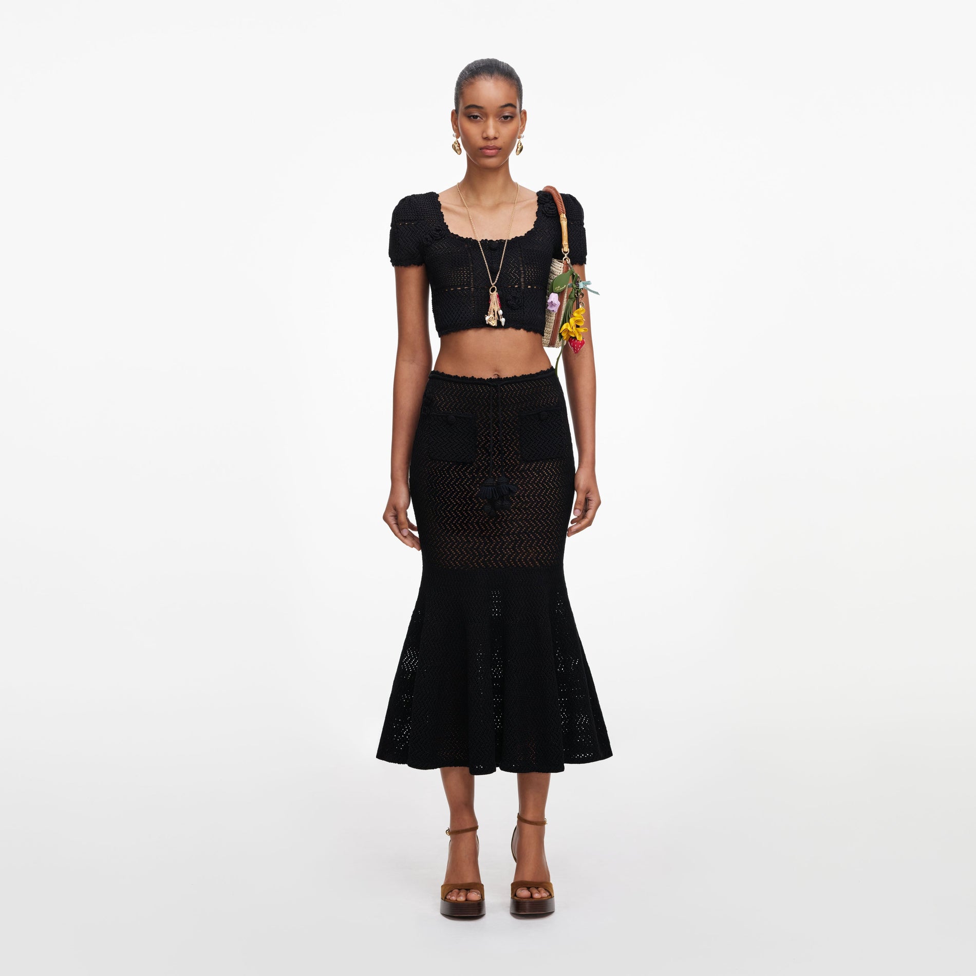 Front view of a woman wearing the Black Crochet Knit Midi Skirt