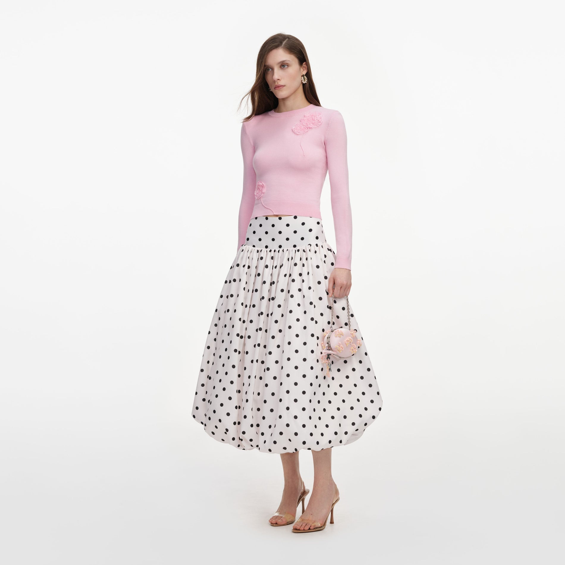 Side view of a woman wearing the Pink Flower Knit Jumper