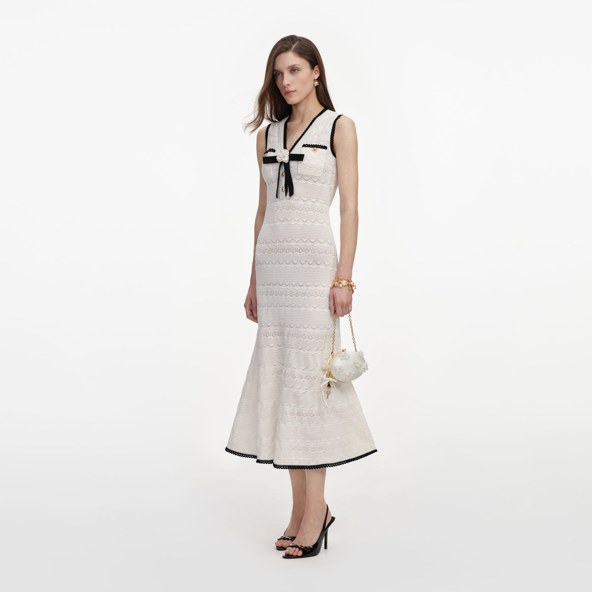 Side view of a woman wearing the White Pointelle Knit Midi Dress