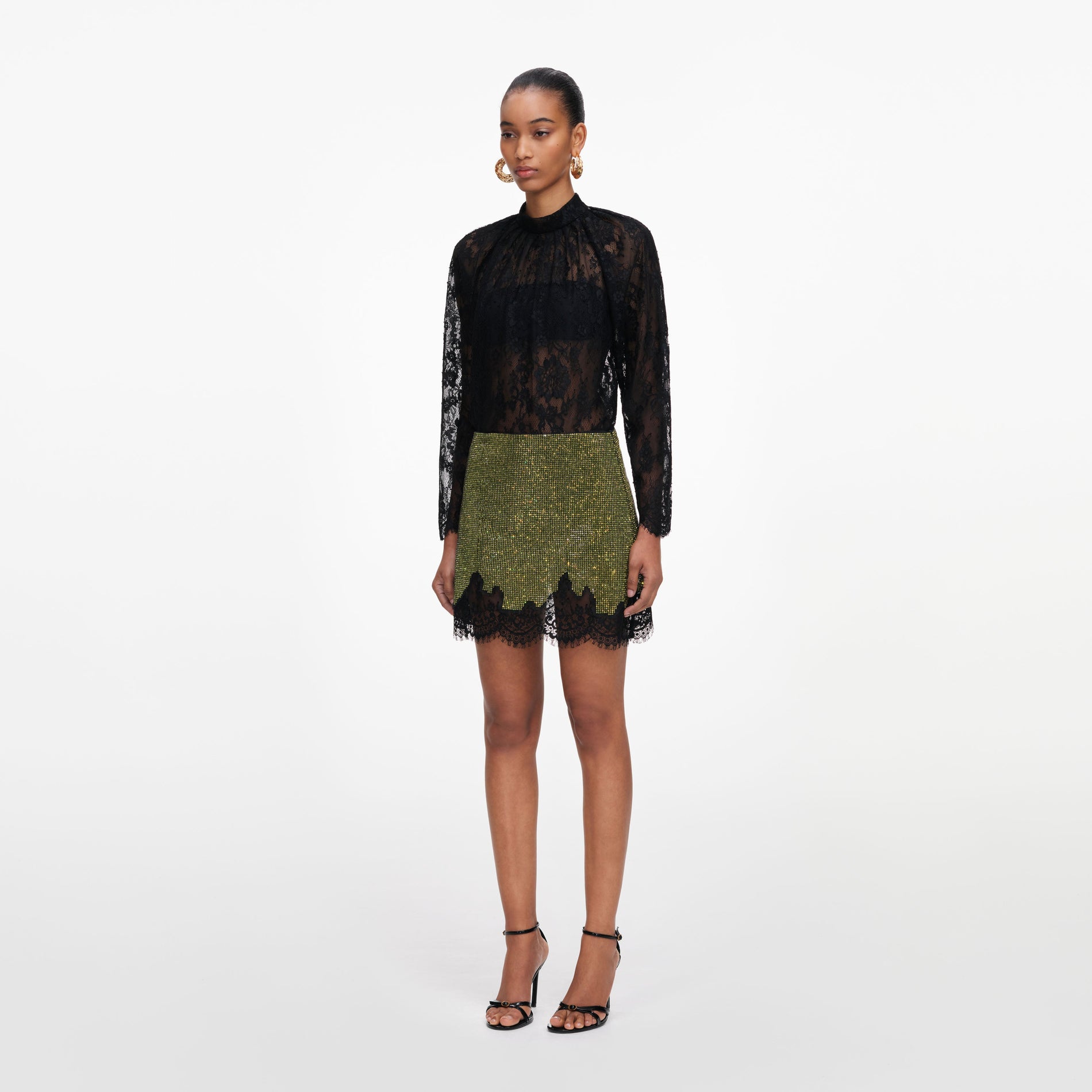 Side view of a woman wearing the Green Crystal Chainmail Mini Skirt