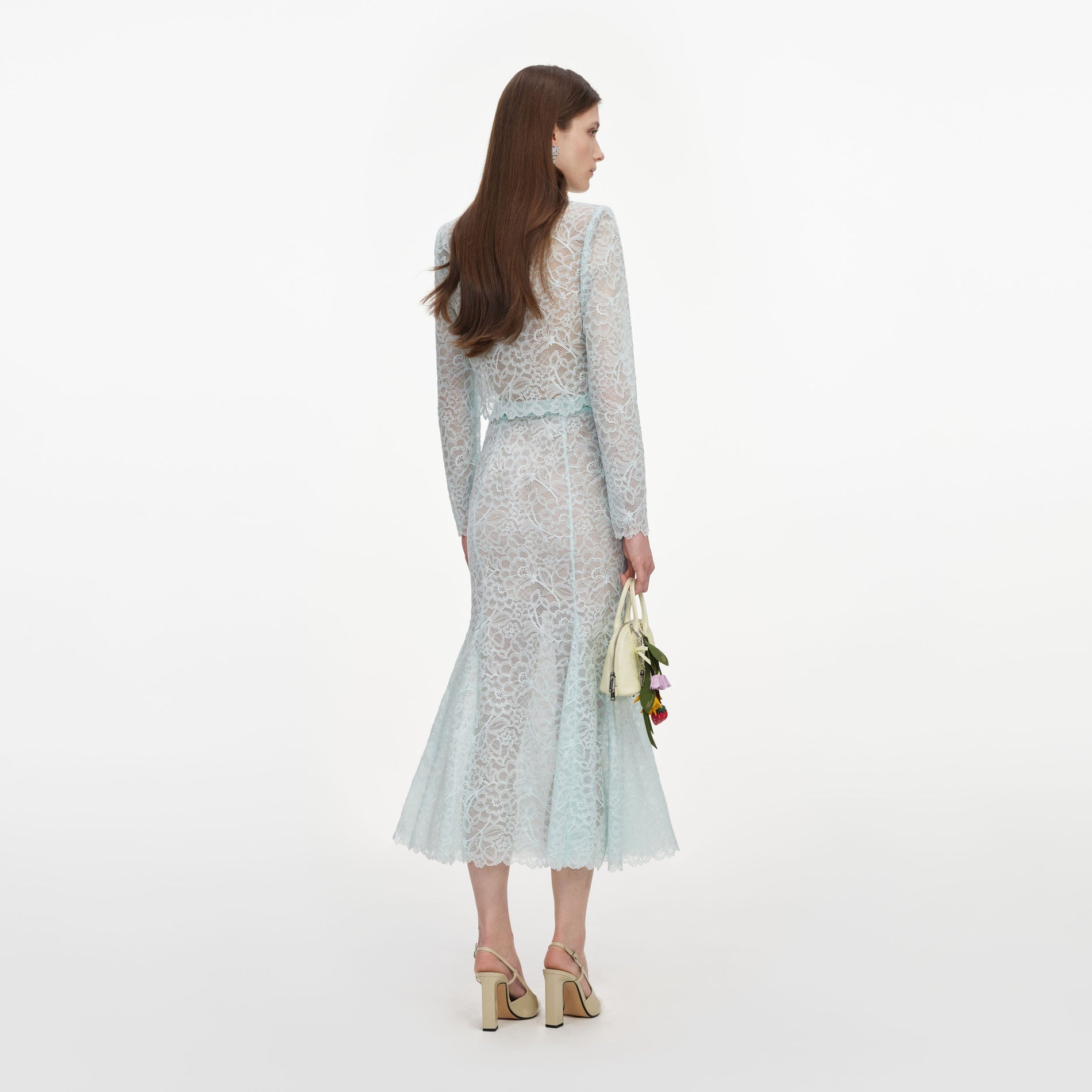 Back view of a woman wearing the Mint Lace Midi Skirt
