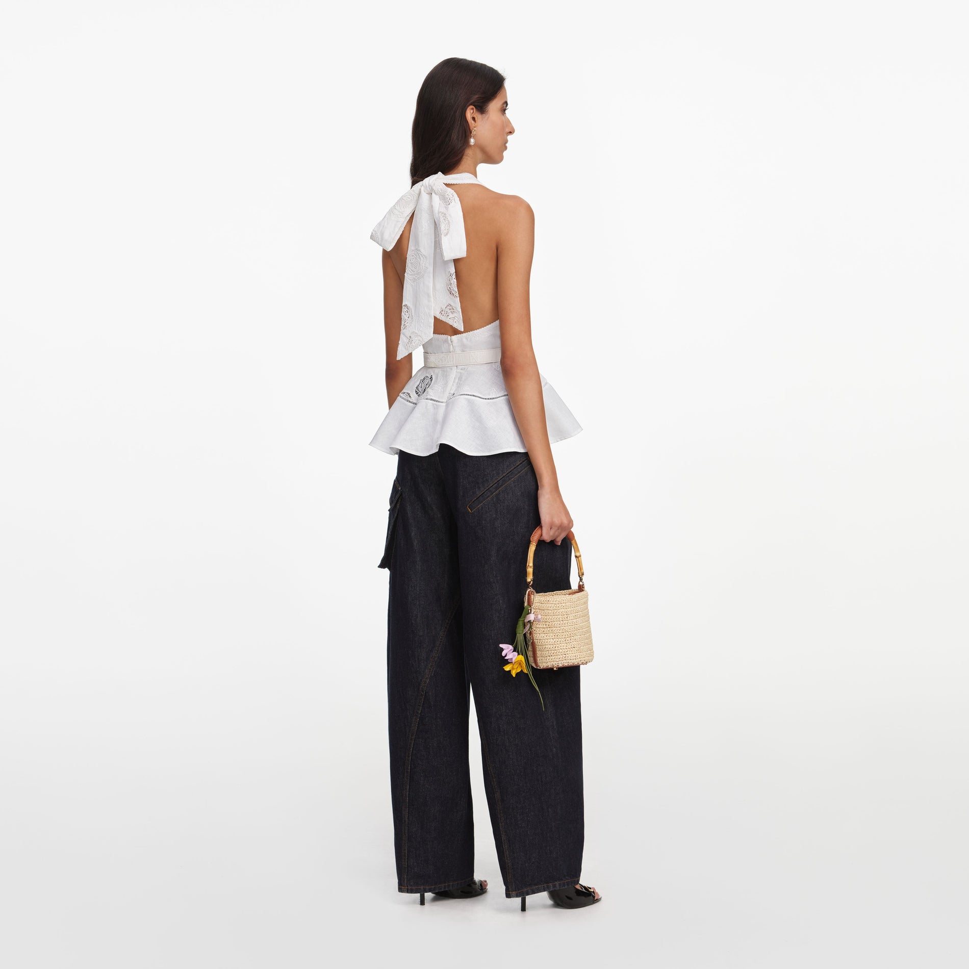 Back view of a woman wearing the White Linen Blend Peplum Top