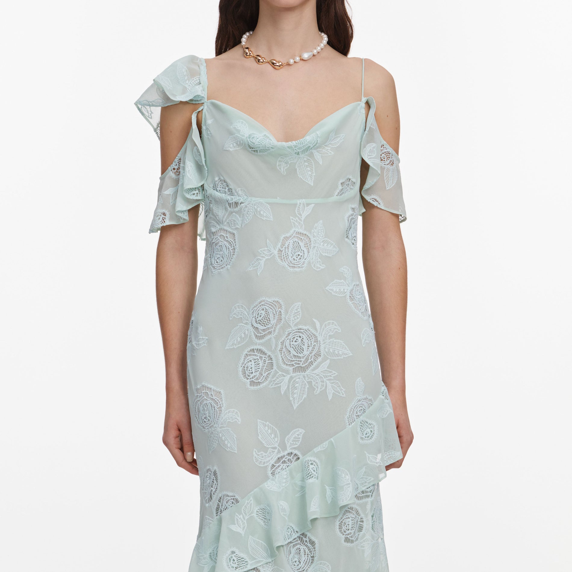 A close up of a woman wearing the Mint Embroidered Georgette Maxi Dress