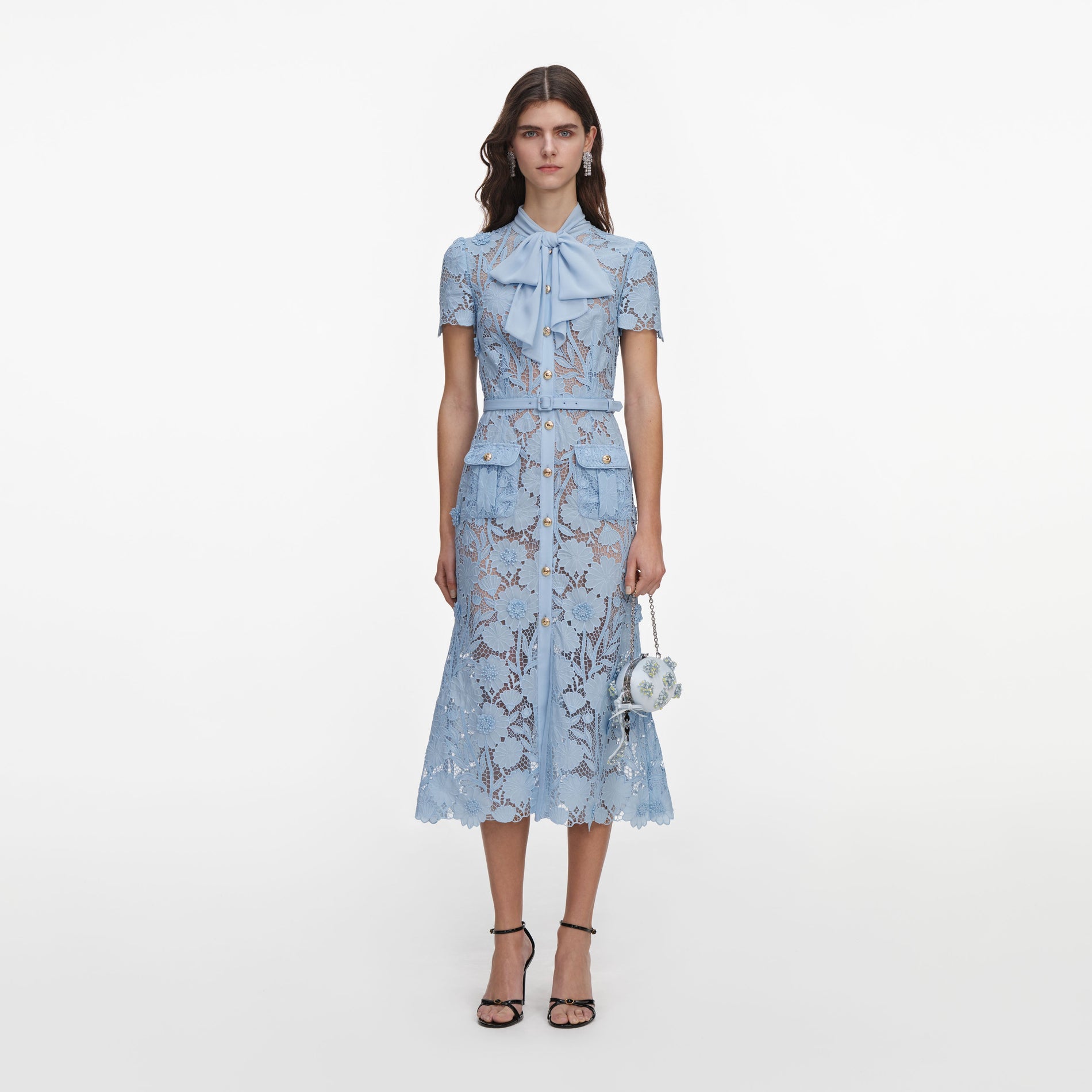 Front view of a woman wearing the Blue Lace Tie Neck Midi Dress