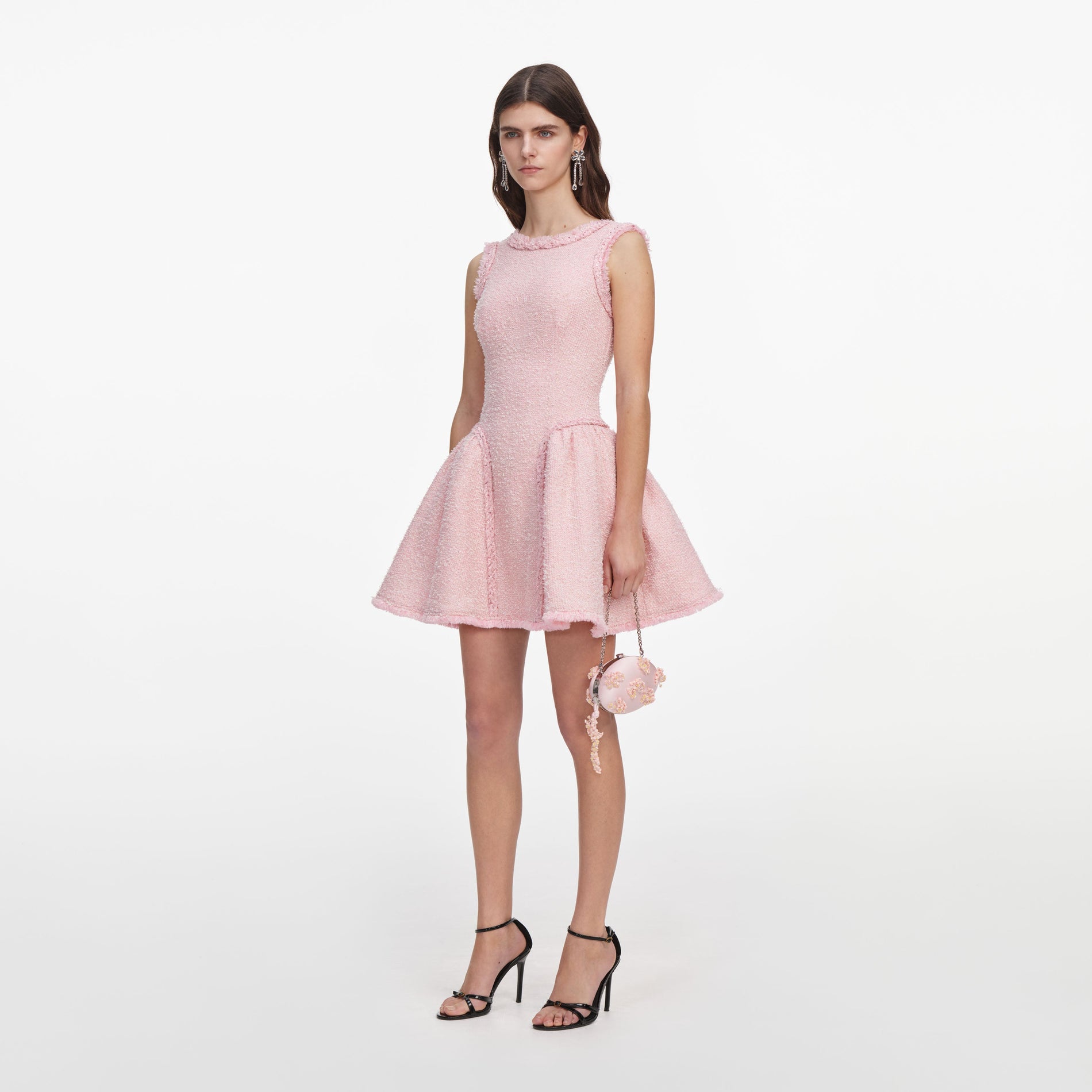 Side view of a woman wearing the Pink Boucle Sleeveless Mini Dress