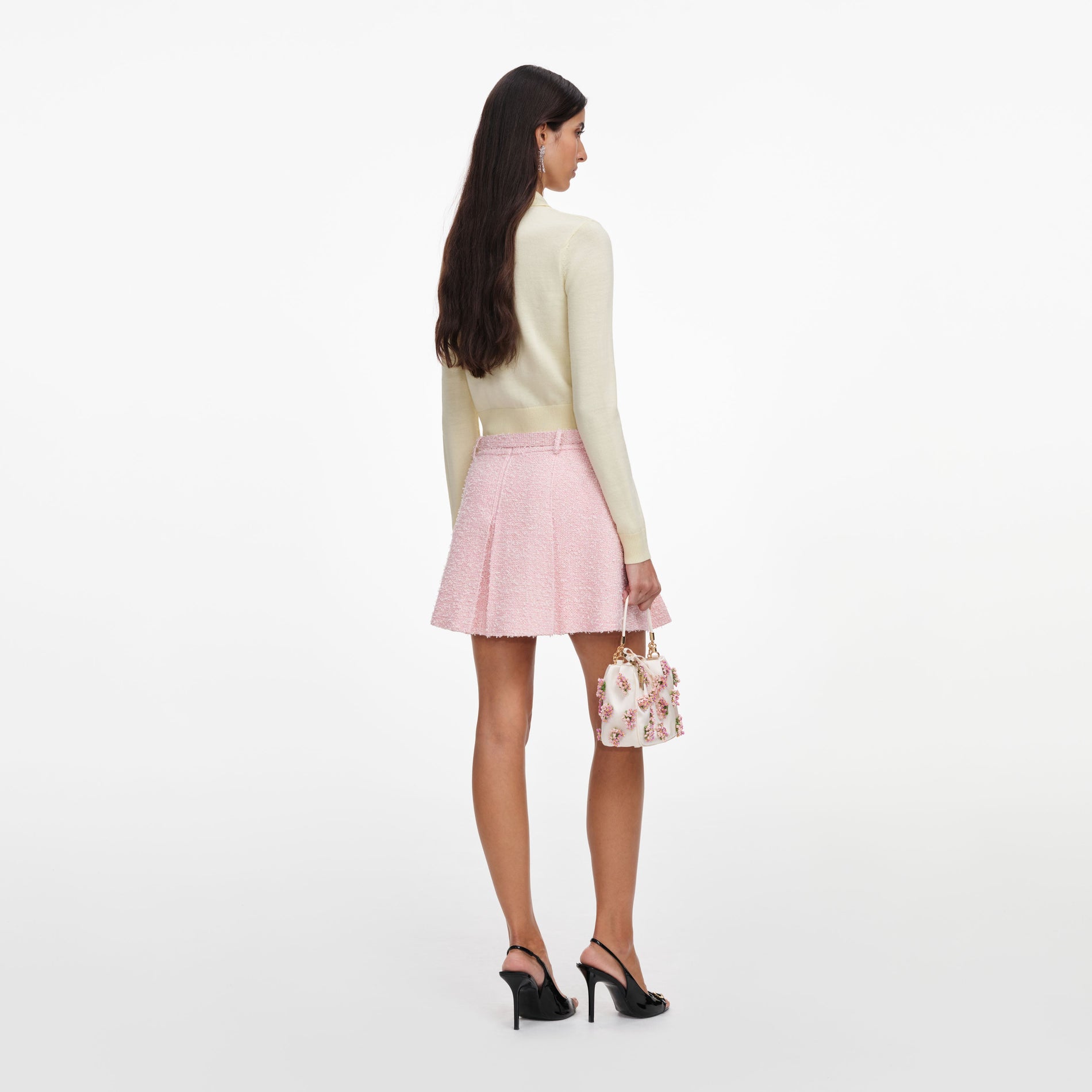 Back view of a woman wearing the Pink Boucle Mini Skirt