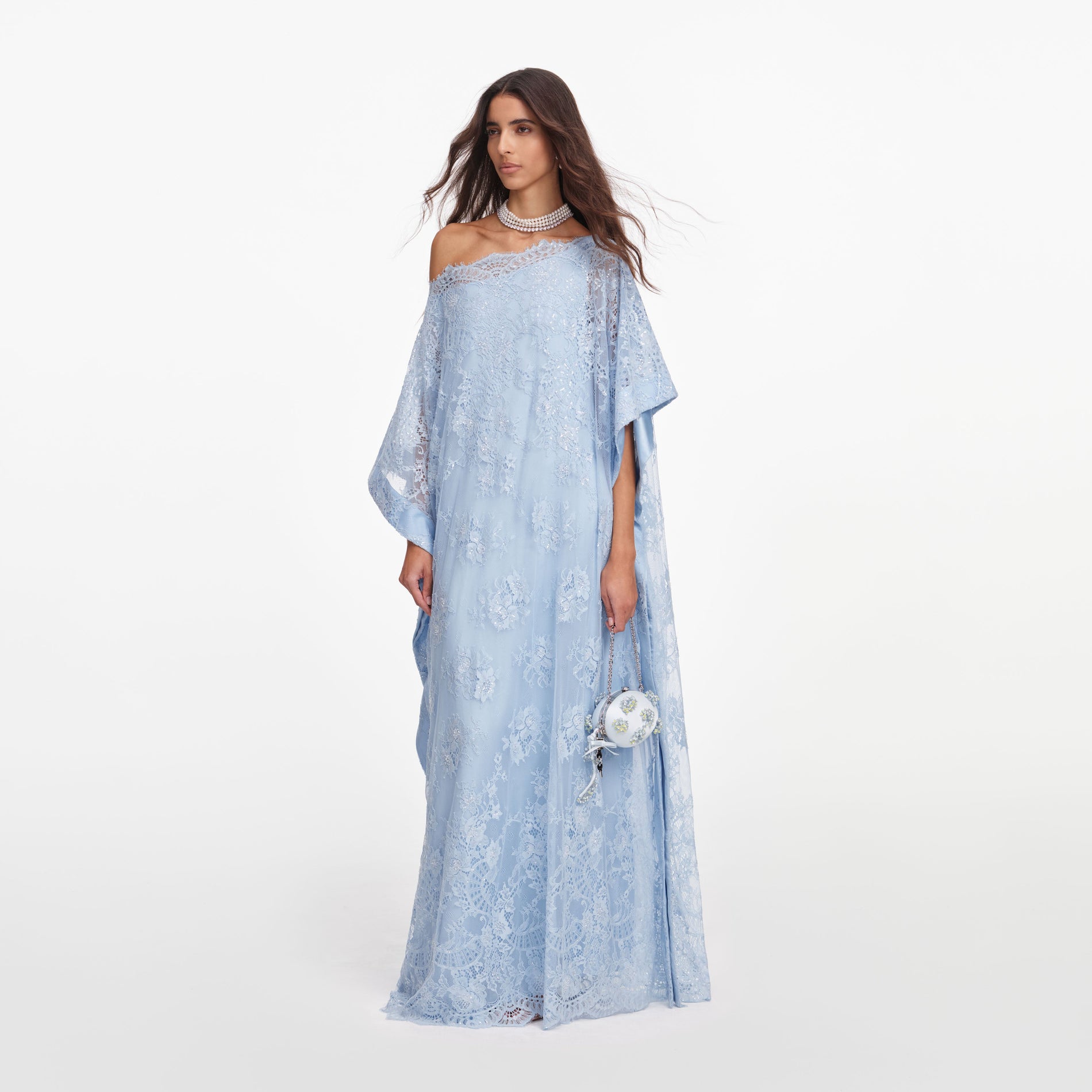 Side view of a woman wearing the Blue Embellished Lace Kaftan