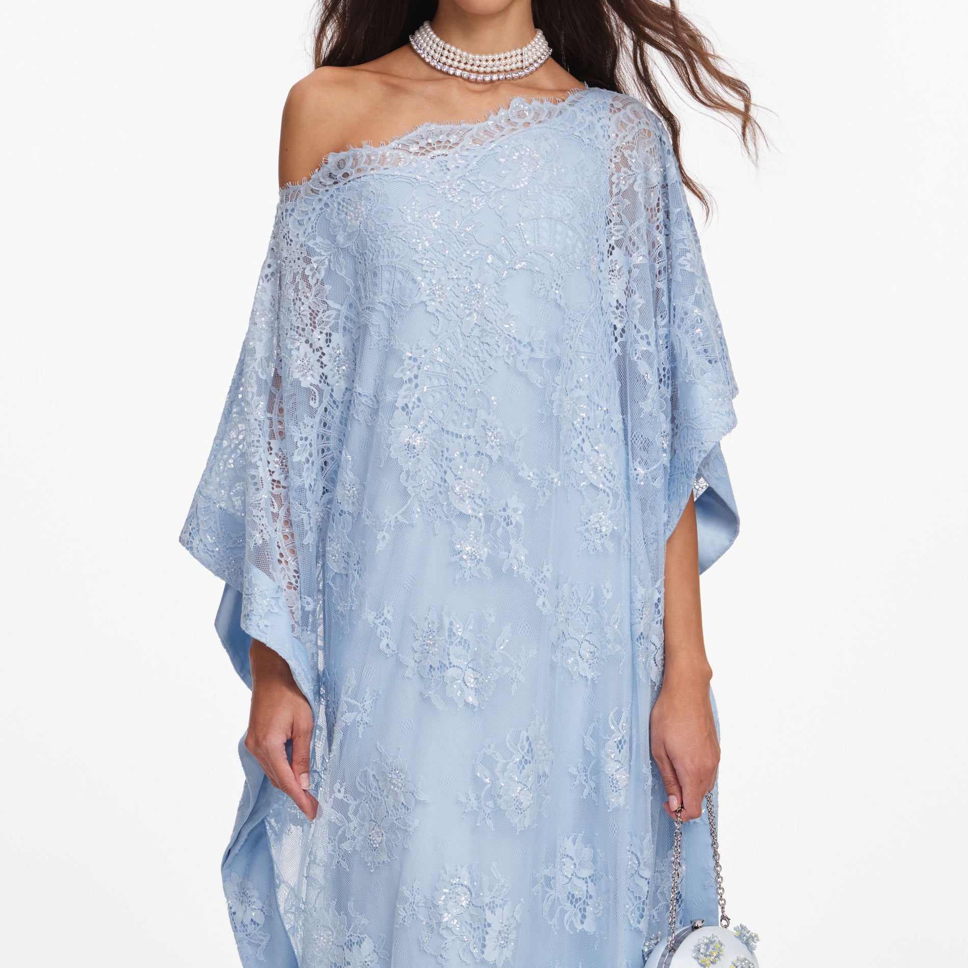 A close up of a woman wearing the Blue Embellished Lace Kaftan