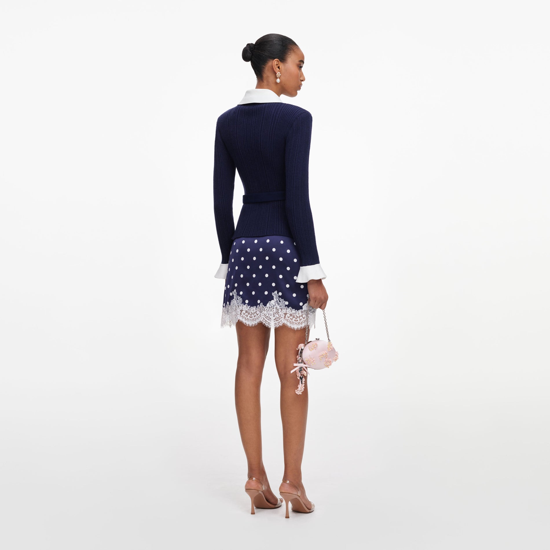 Back view of a woman wearing the Navy Ribbed Knit Cardigan