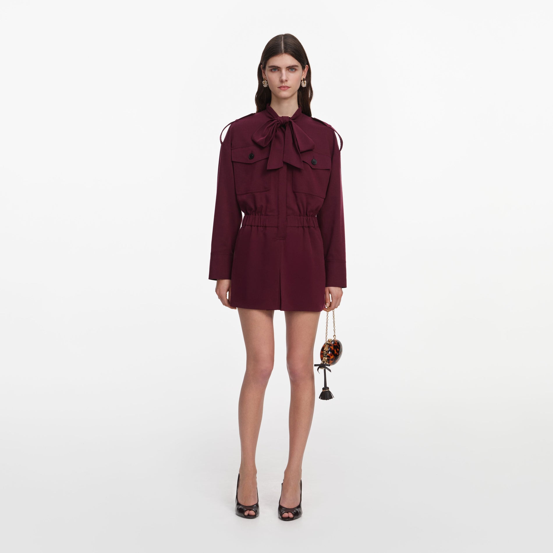 Front view of a woman wearing the Plum Twill Tie Neck Playsuit