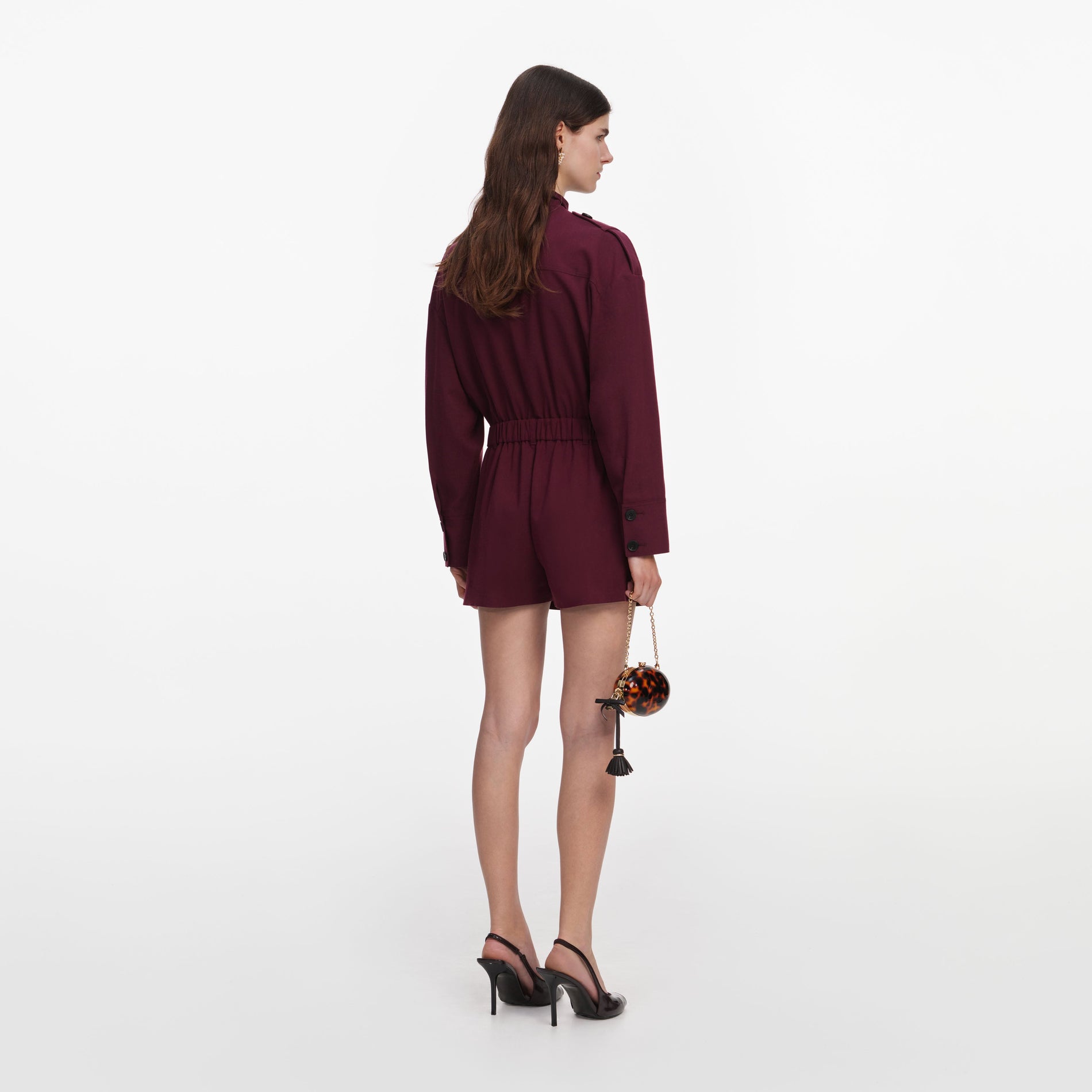 Back view of a woman wearing the Plum Twill Tie Neck Playsuit
