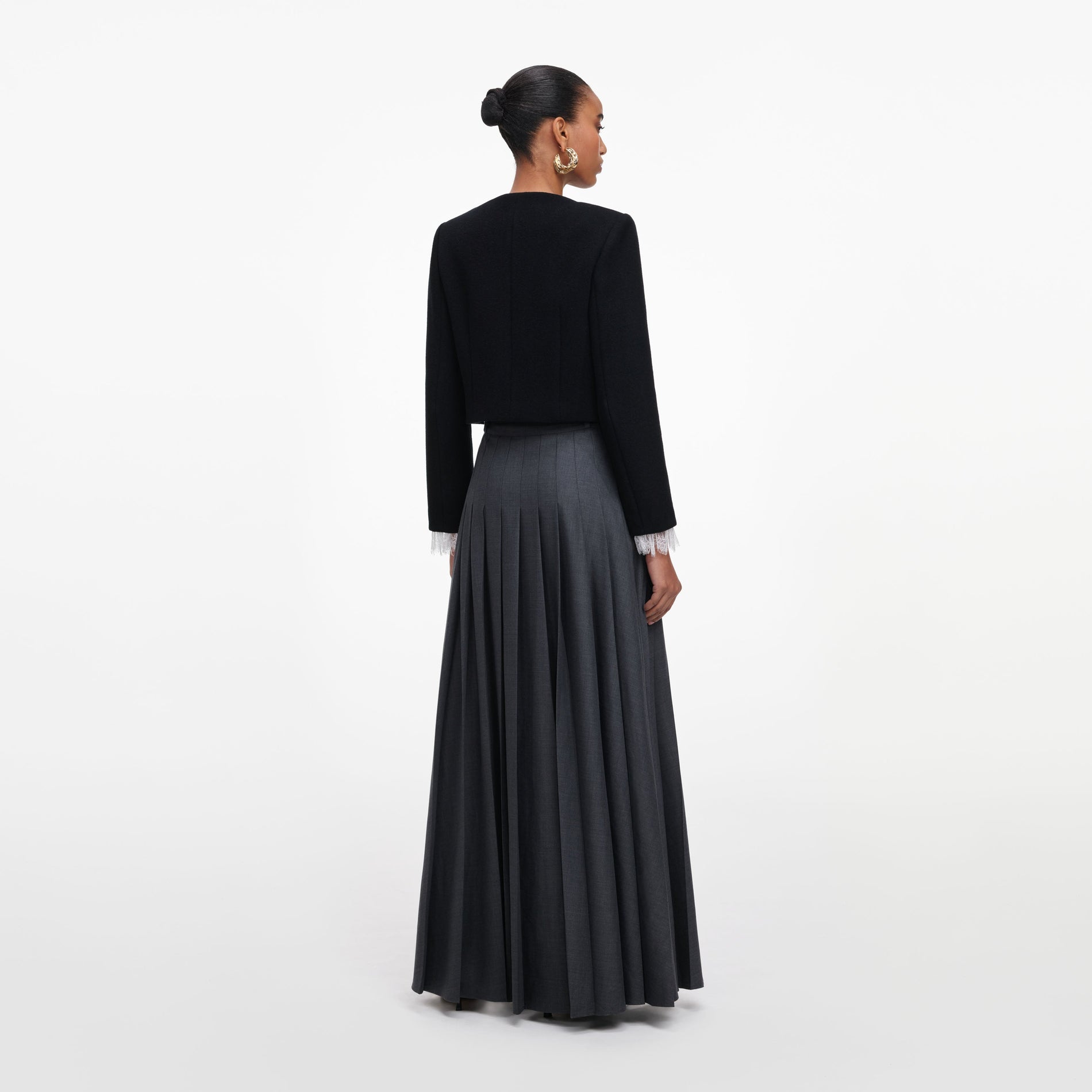 Back view of a woman wearing the Grey Pleated Maxi Skirt