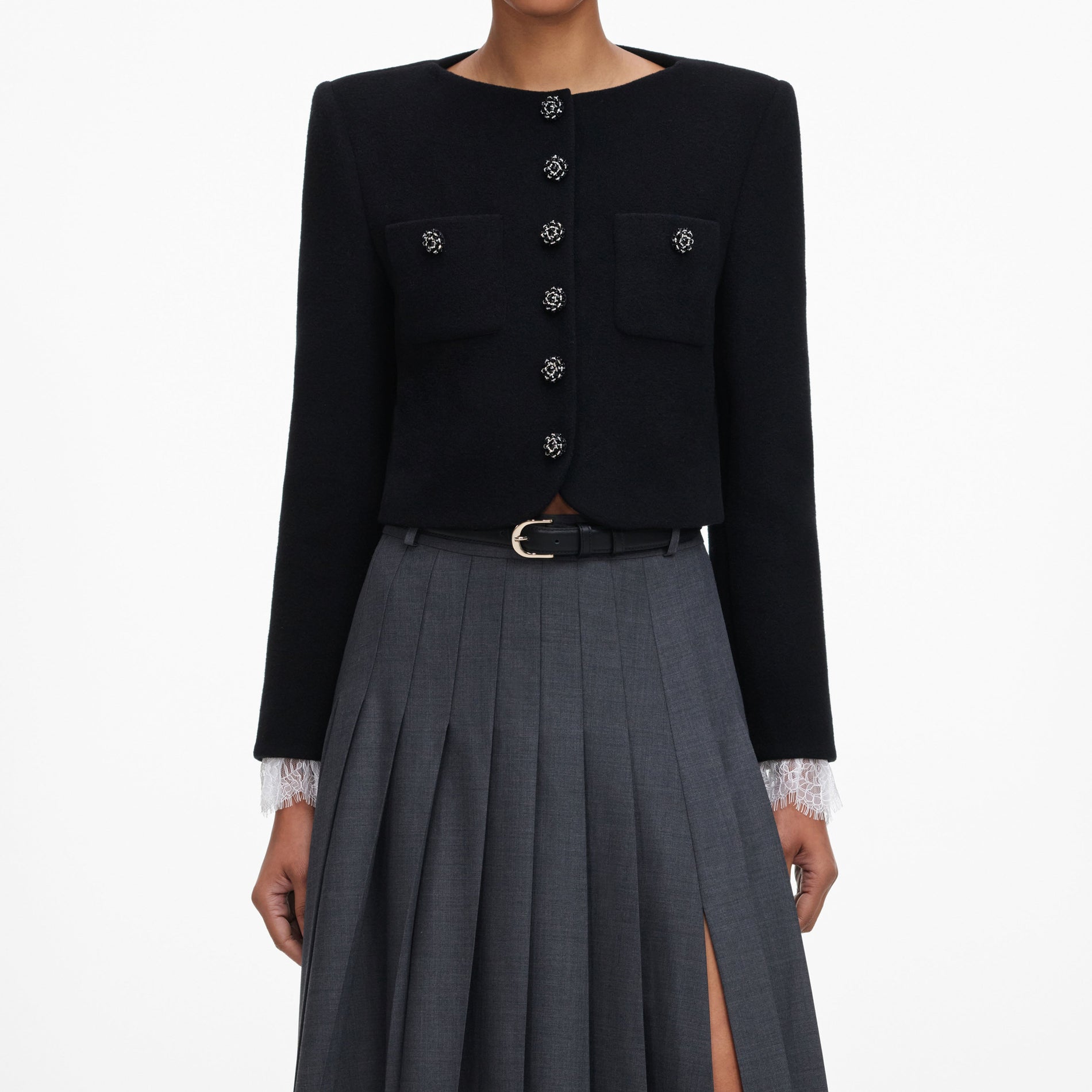 A close up of a woman wearing the Grey Pleated Maxi Skirt