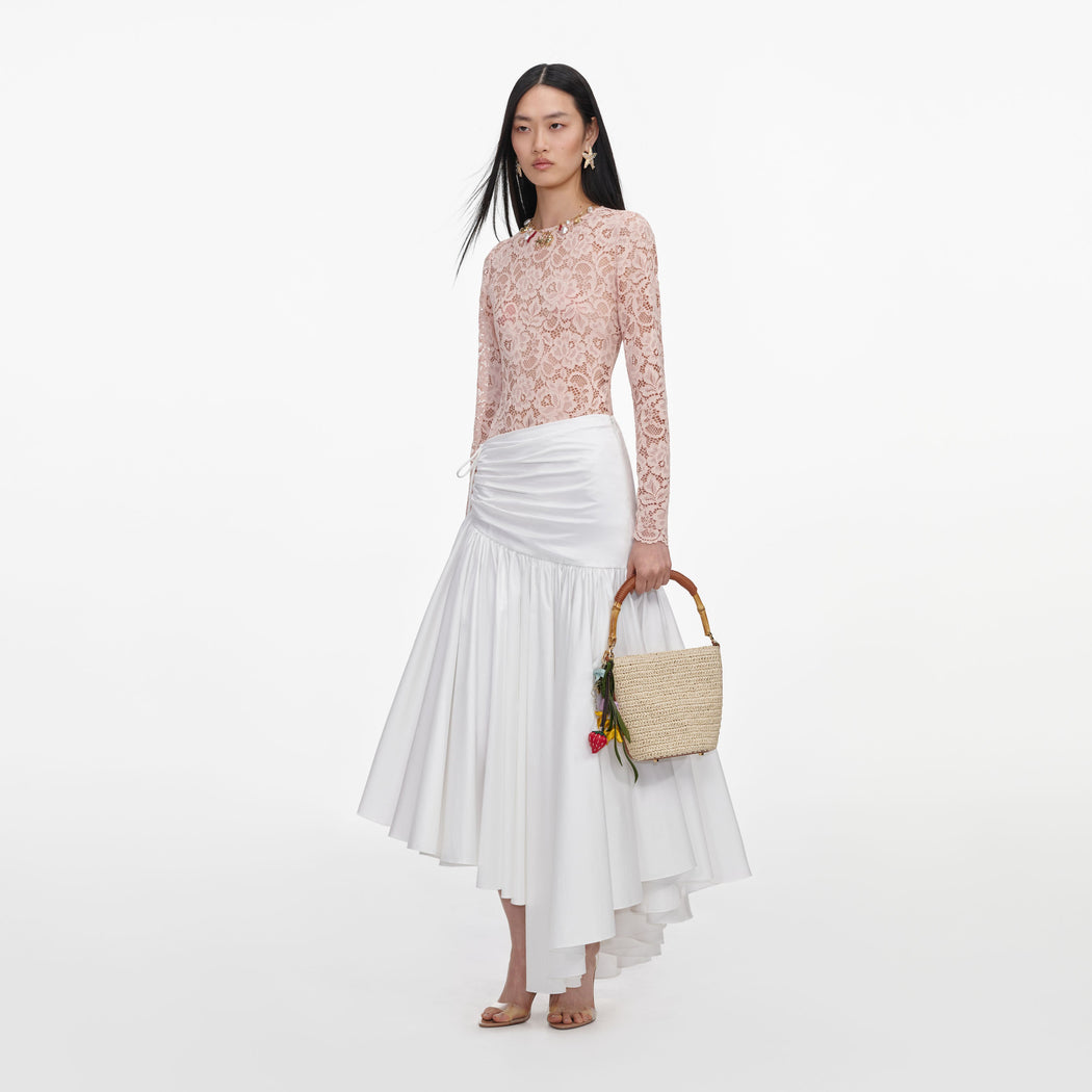 Side view of a woman wearing the Beige Floral Lace Bodysuit