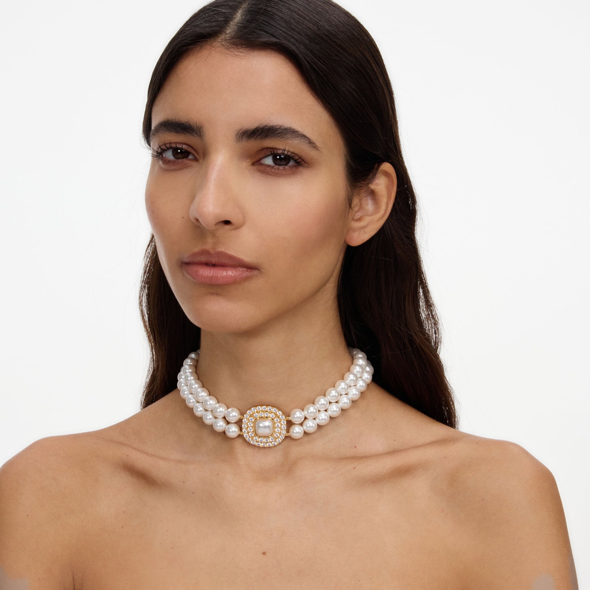 A close up of a woman wearing the Gold Crystal Pearl Choker