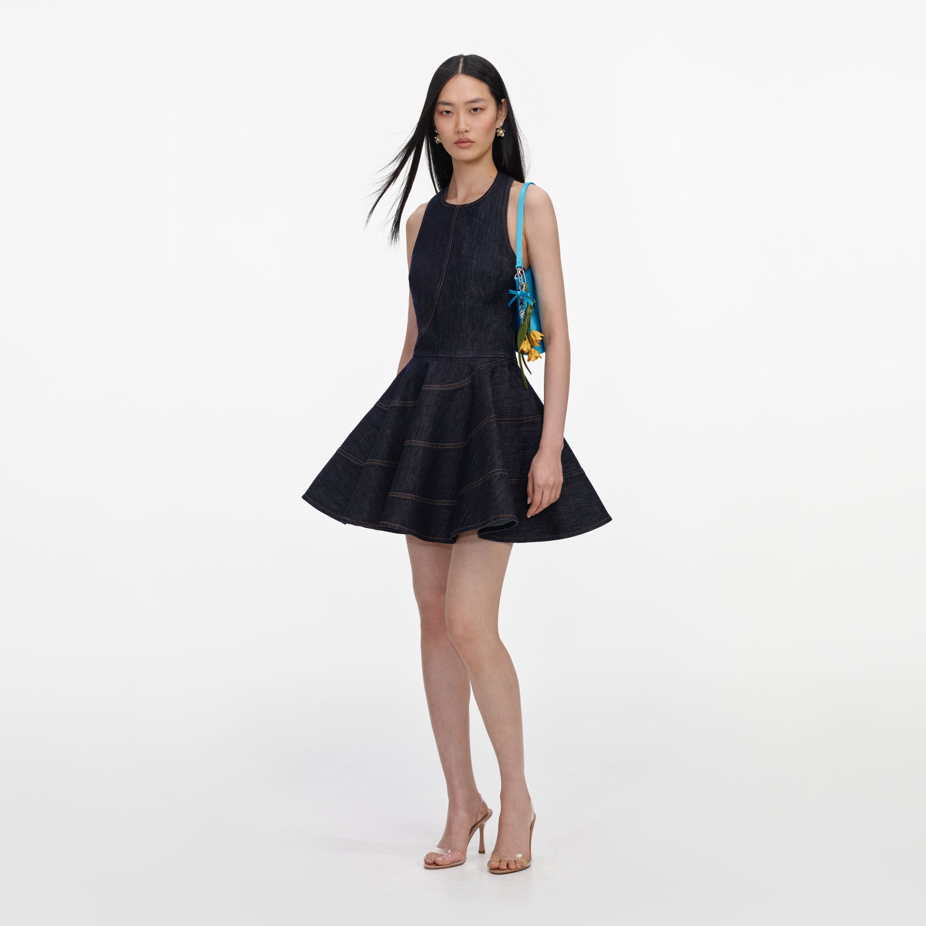 Side view of a woman wearing the Indigo Denim Halterneck Mini Dress