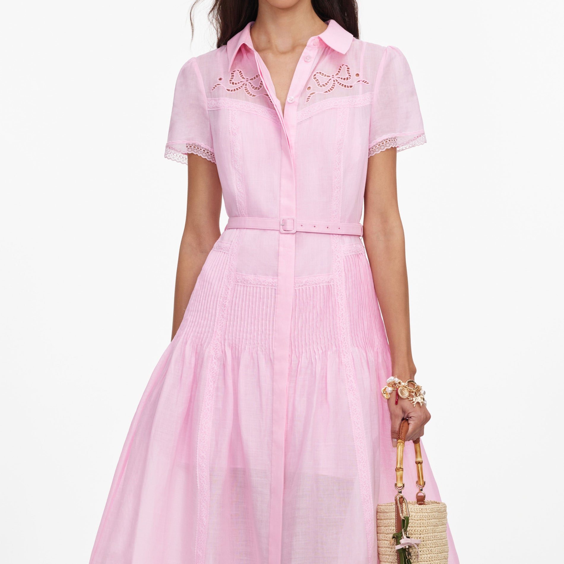 A close up of a woman wearing the Pink Embroidered Midi Dress