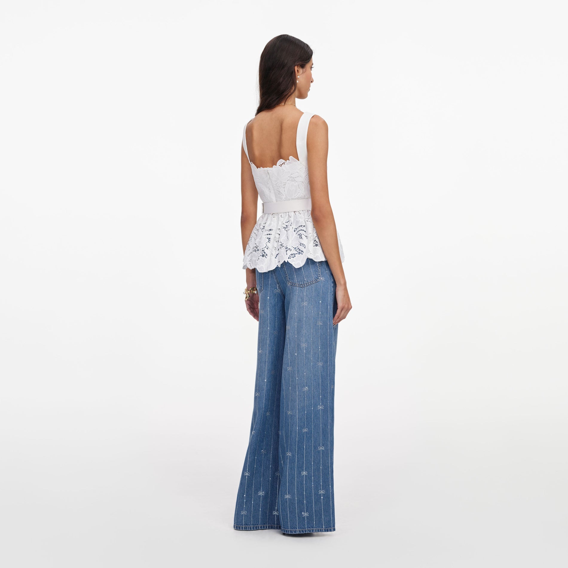 Back view of a woman wearing the White Lace Peplum Top