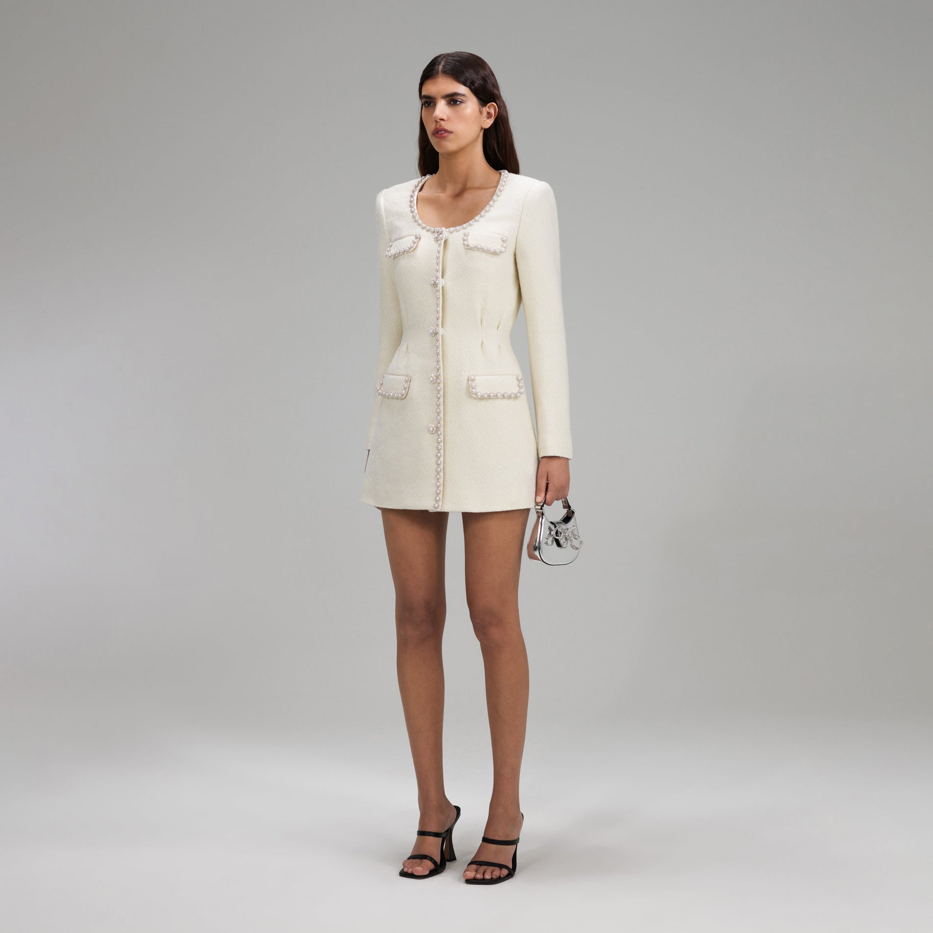 A woman wearing the Cream Boucle Tailored Mini Dress