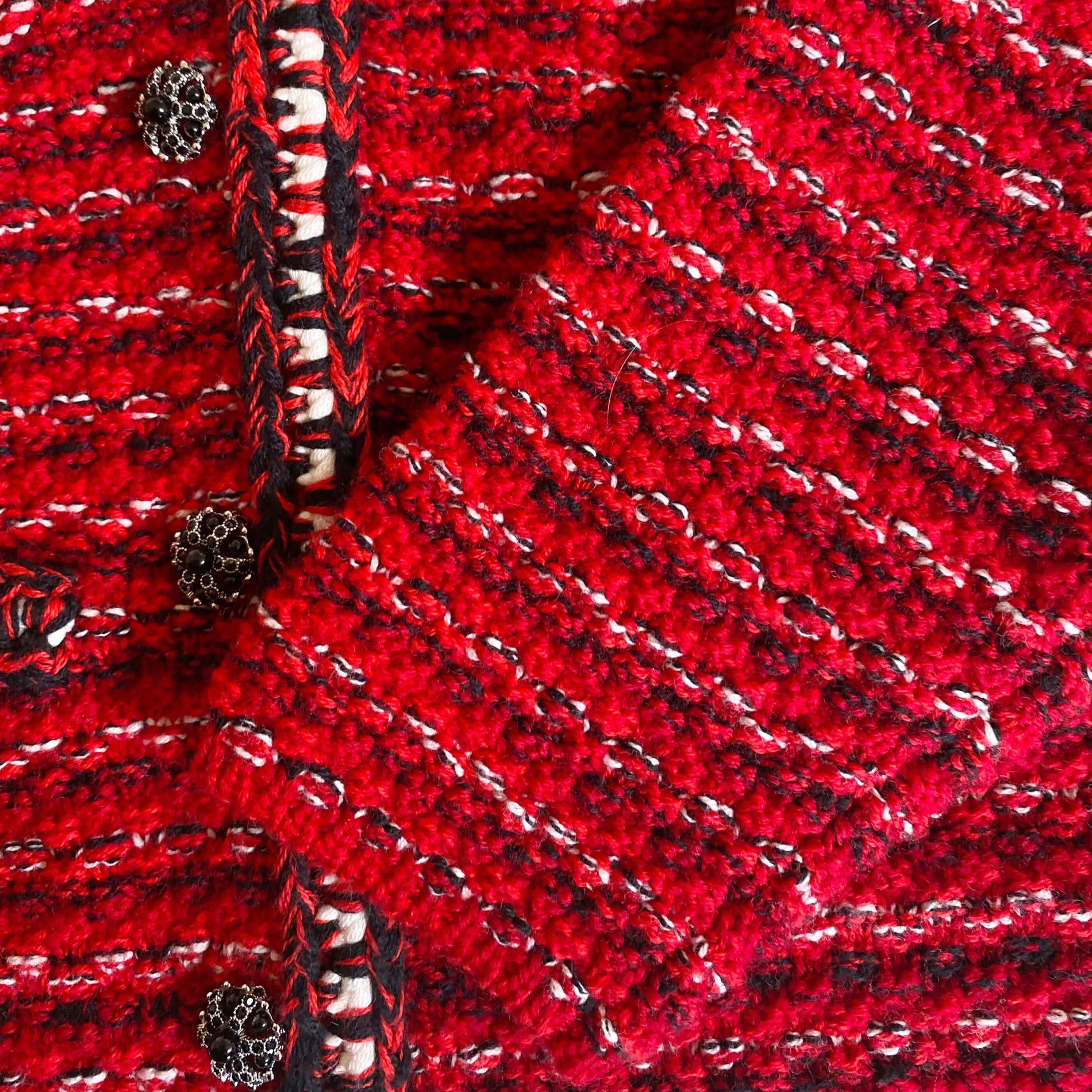 A close up of the fabric for the Red Melange Button Knit Cardigan