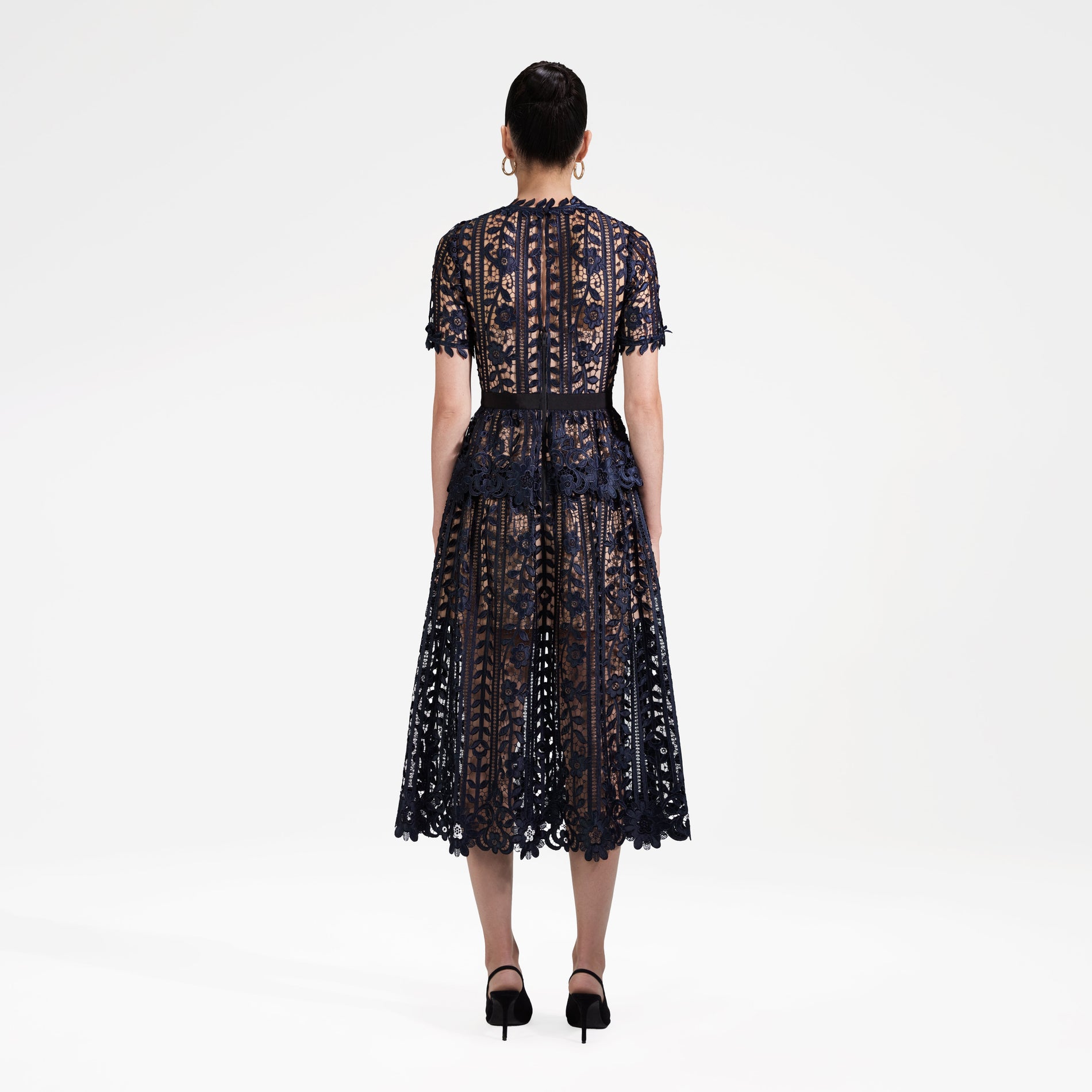 Back view of a woman wearing the Navy Lace Midi Dress