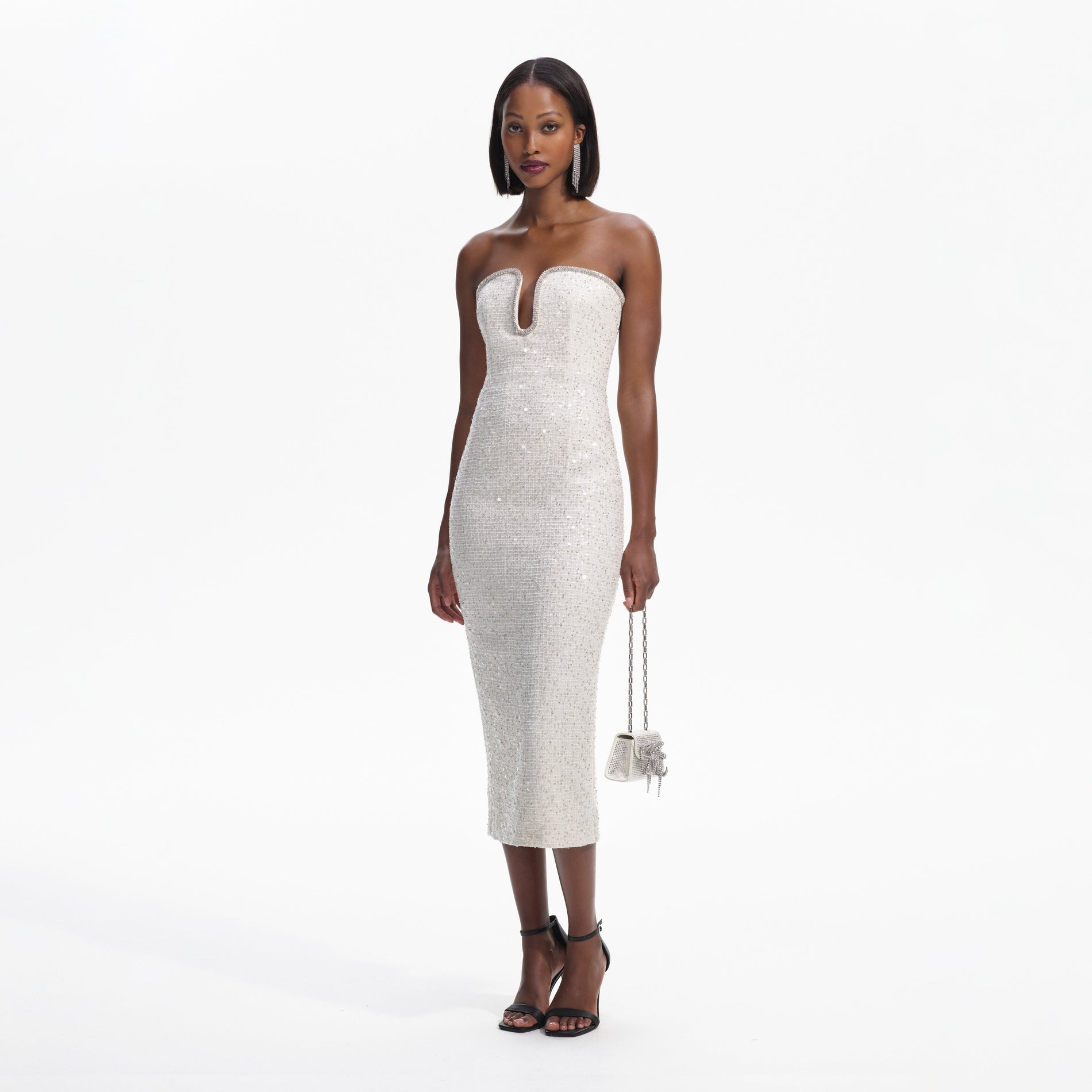 Side view of a woman wearing the Cream Sequin Boucle Strapless Midi Dress