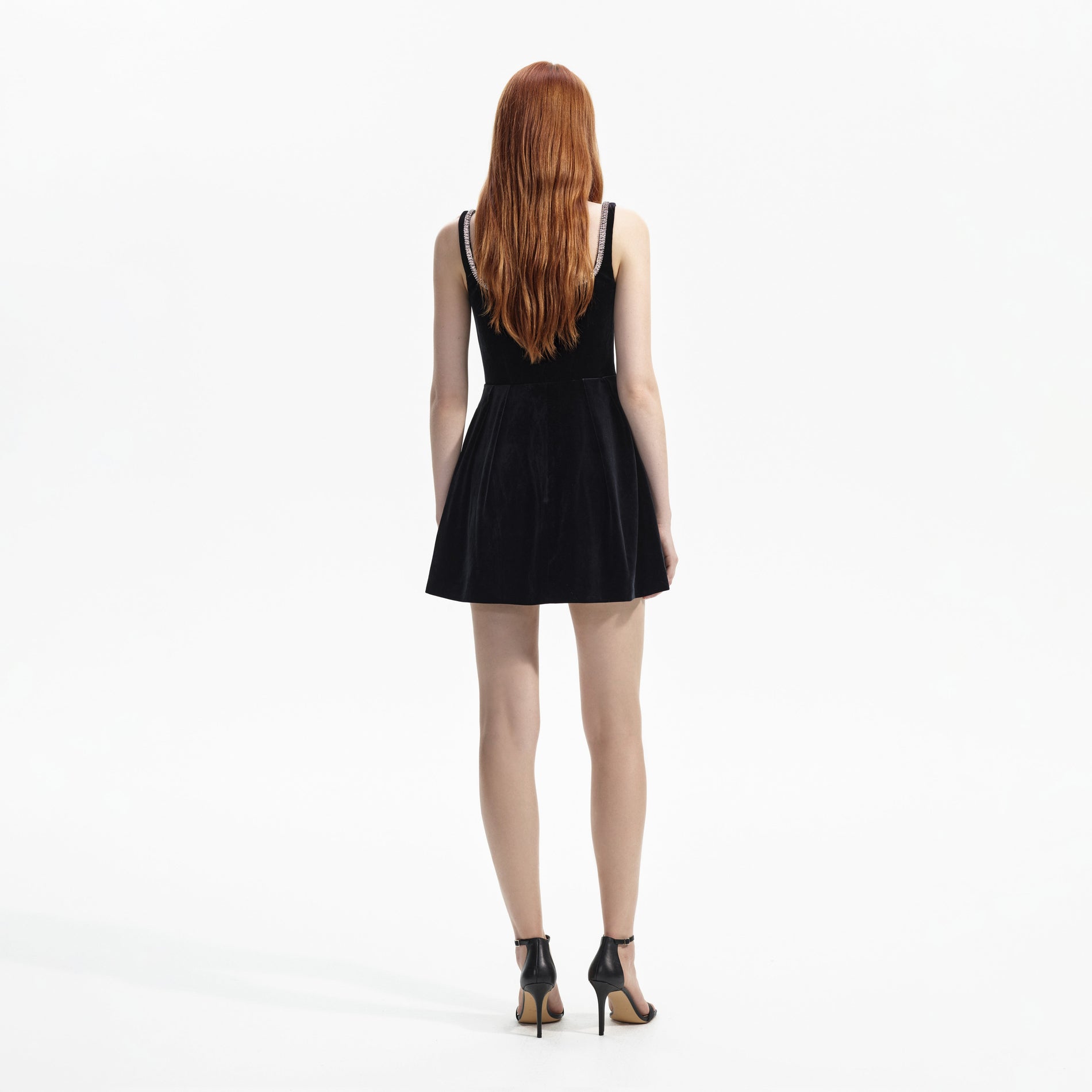 Back view of a woman wearing the Black Velvet Skater Mini Dress
