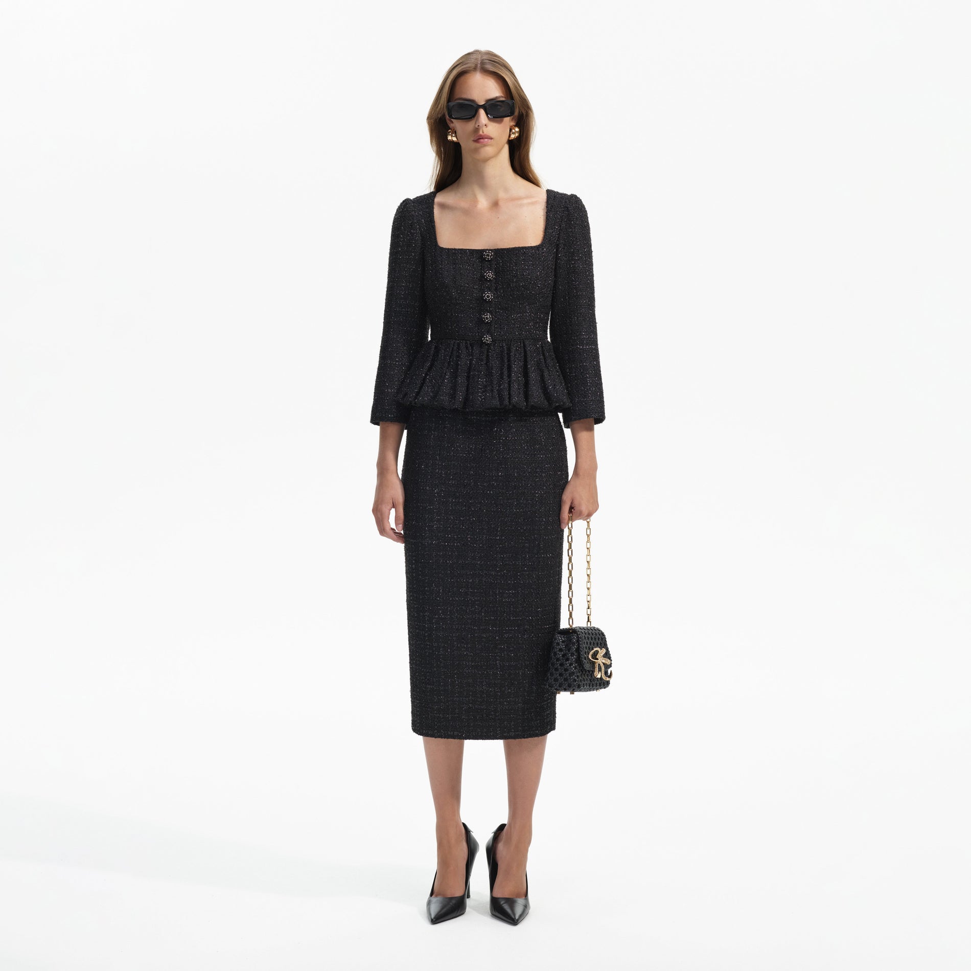 Front view of a woman wearing the Black Boucle Peplum Midi Dress