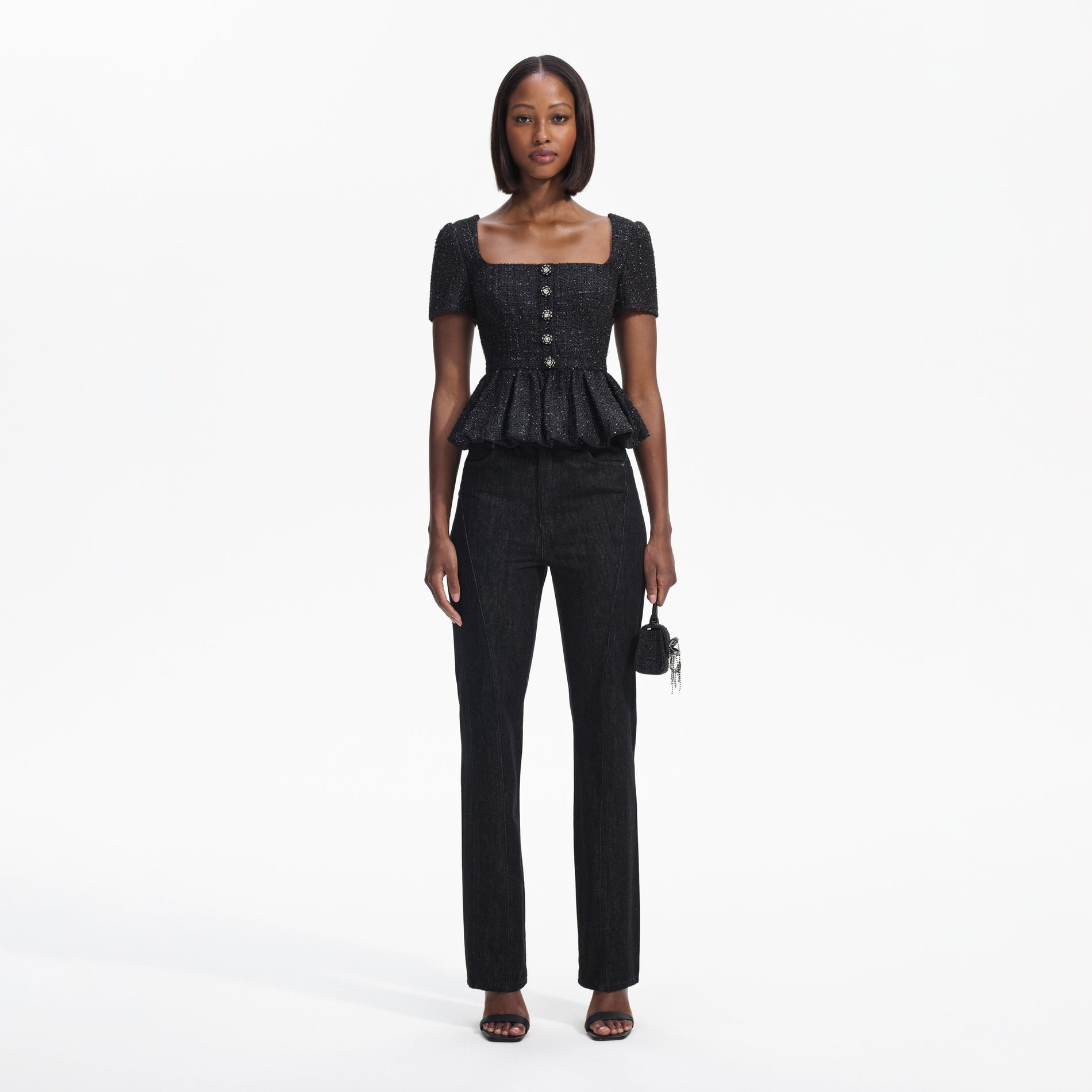 Front view of a woman wearing the Black Boucle Peplum Top