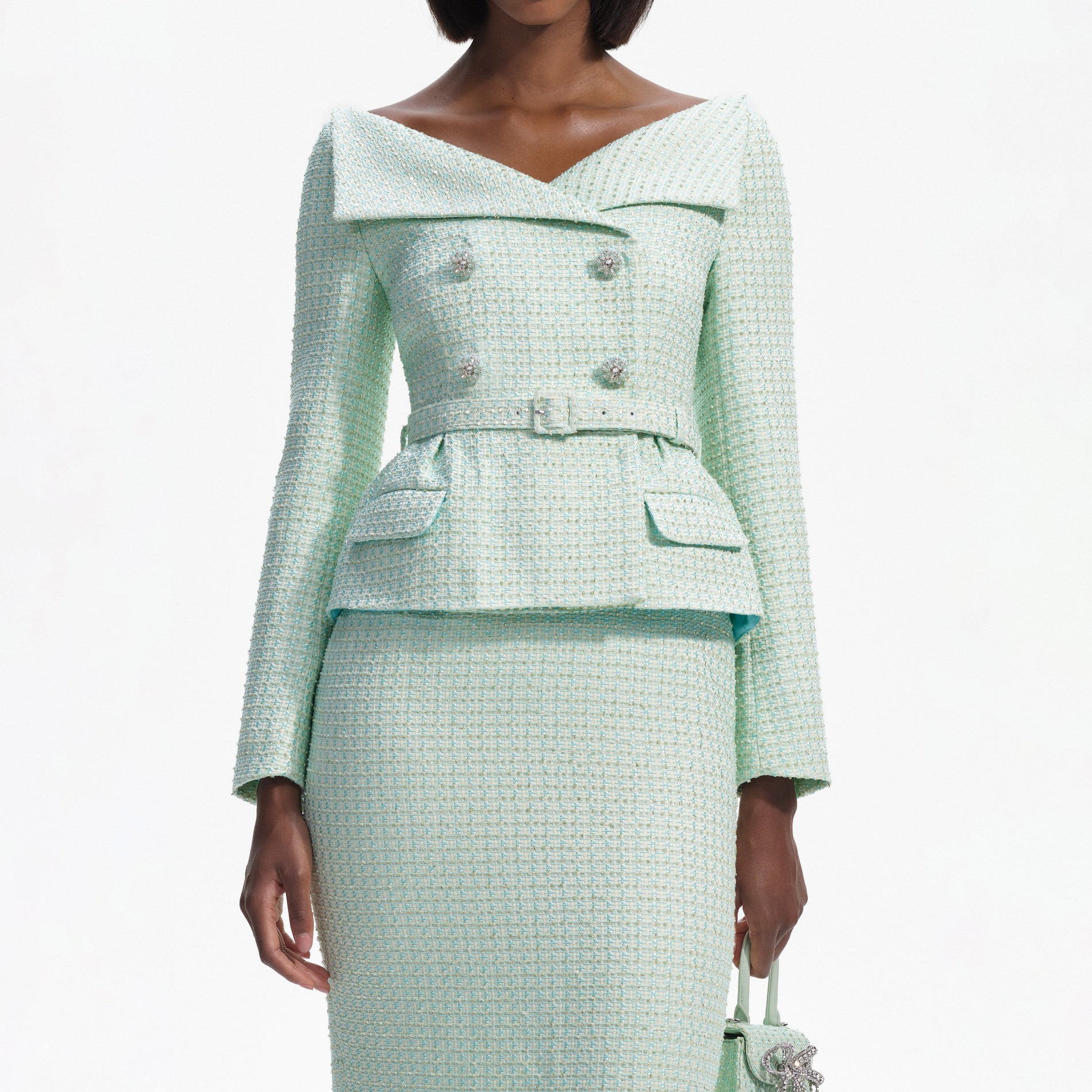 A close up of a woman wearing the Mint Boucle Tailored Midi Dress