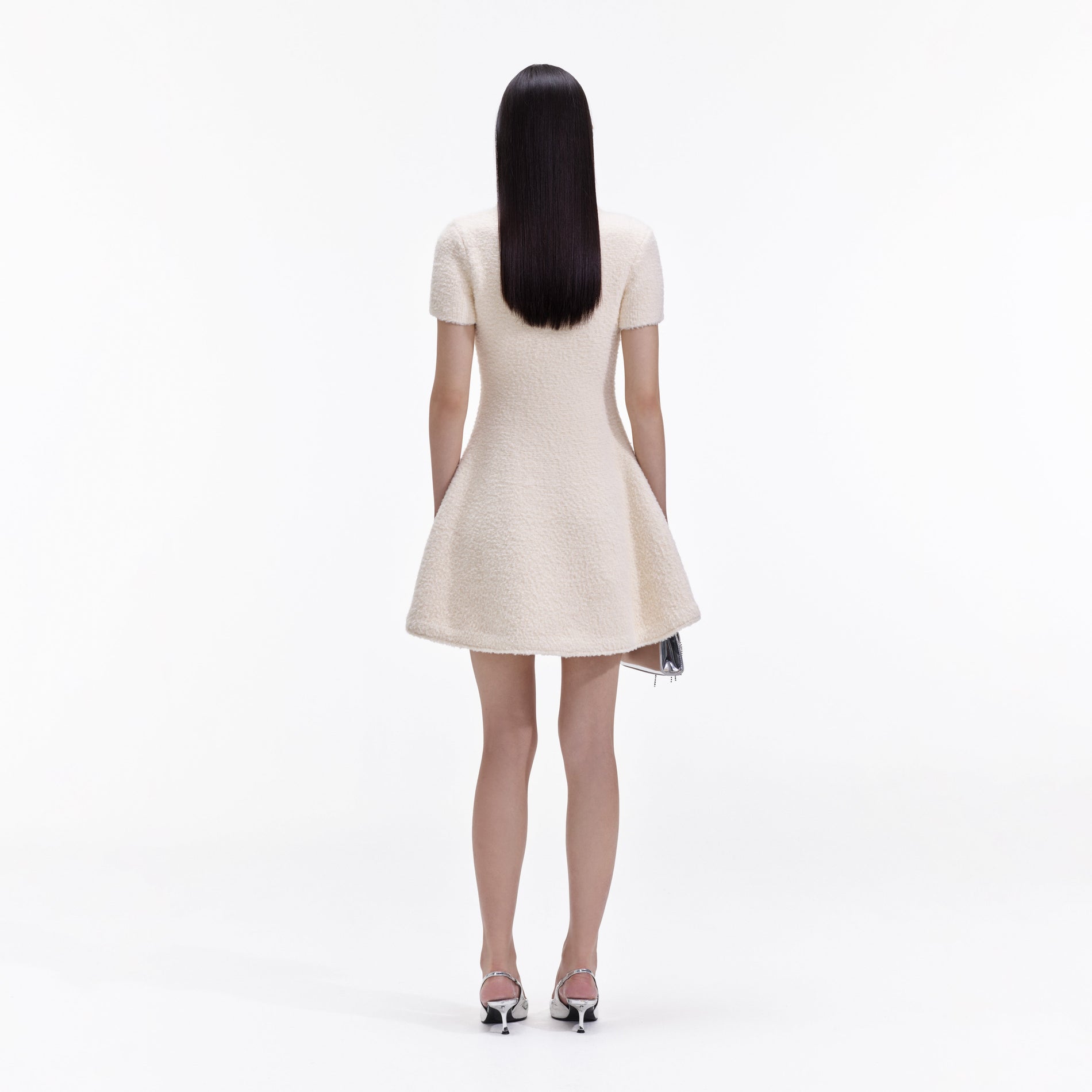 Back view of a woman wearing the Cream Soft Knit Mini Dress
