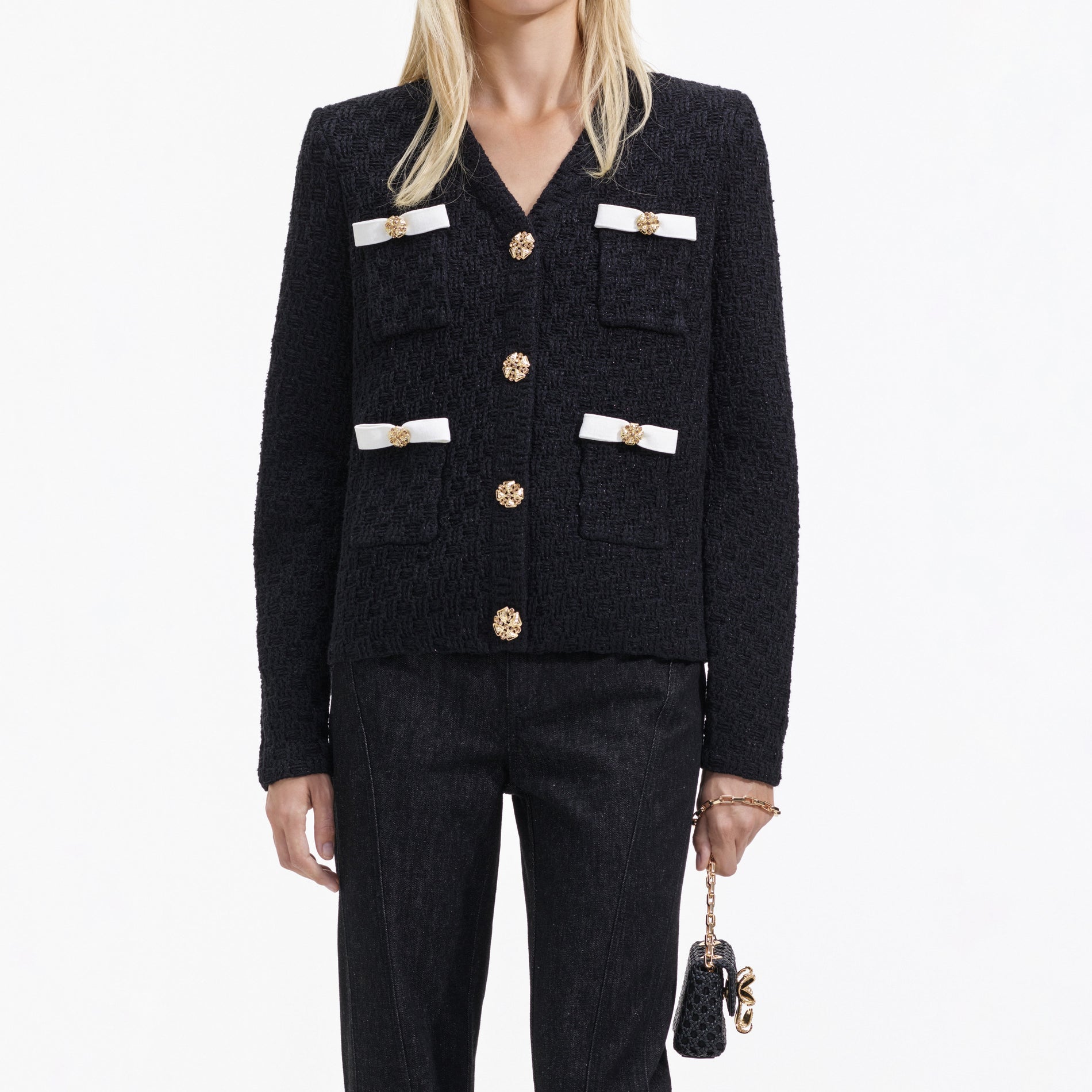 A close up of a woman wearing the Black Weave Cardigan