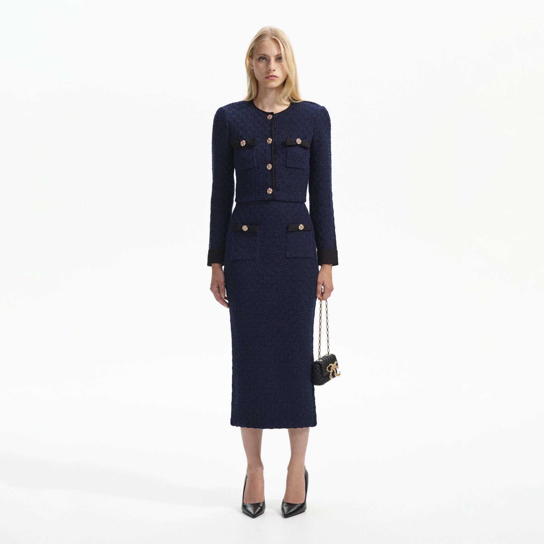 Front view of a woman wearing the Navy Weave Knit Midi Skirt