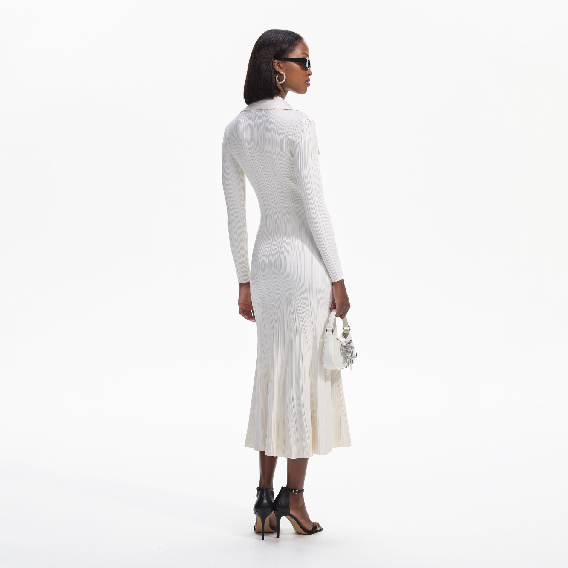 Back view of a woman wearing the Cream Knit Midi Dress