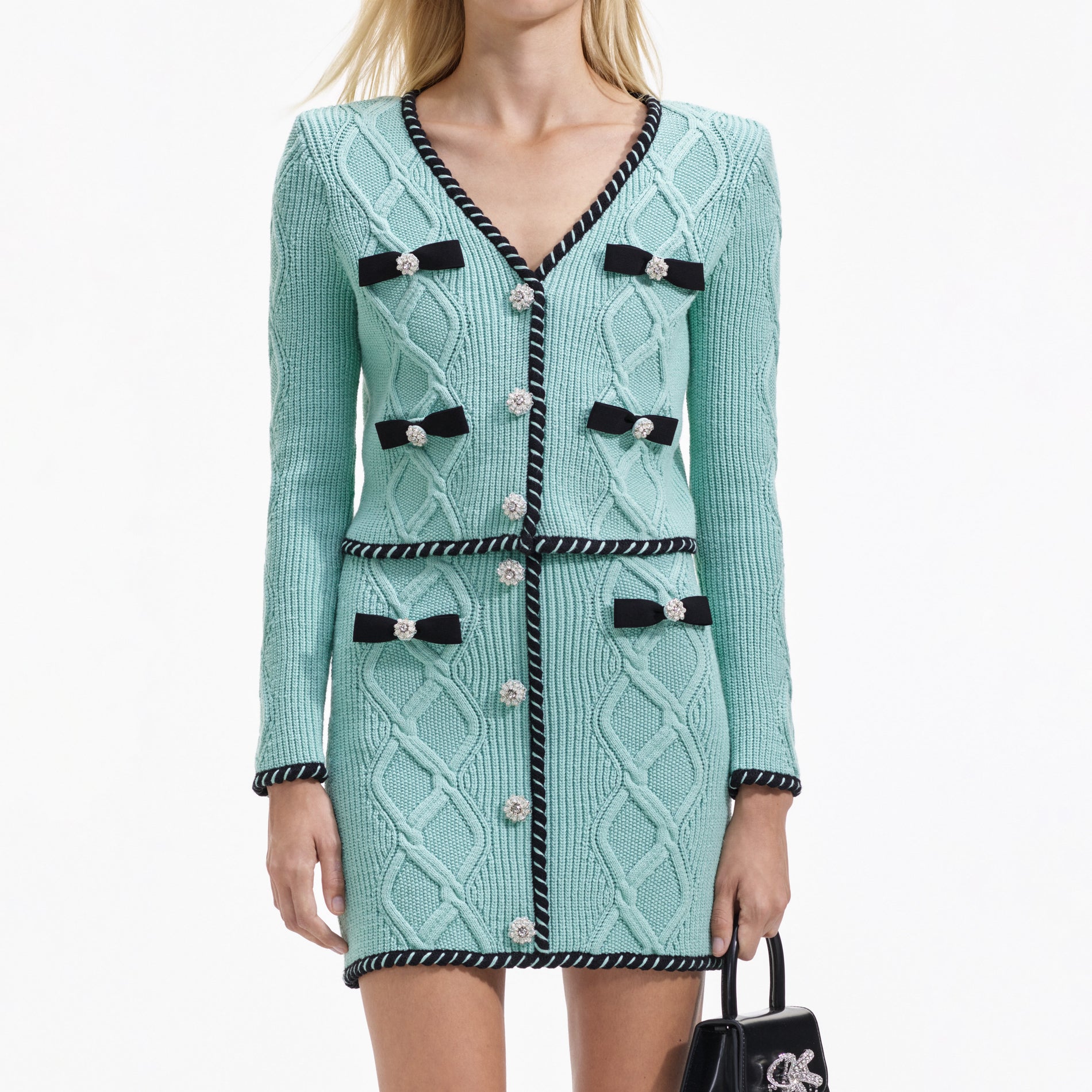 A close up of a woman wearing the Mint Cable Knit Mini Skirt