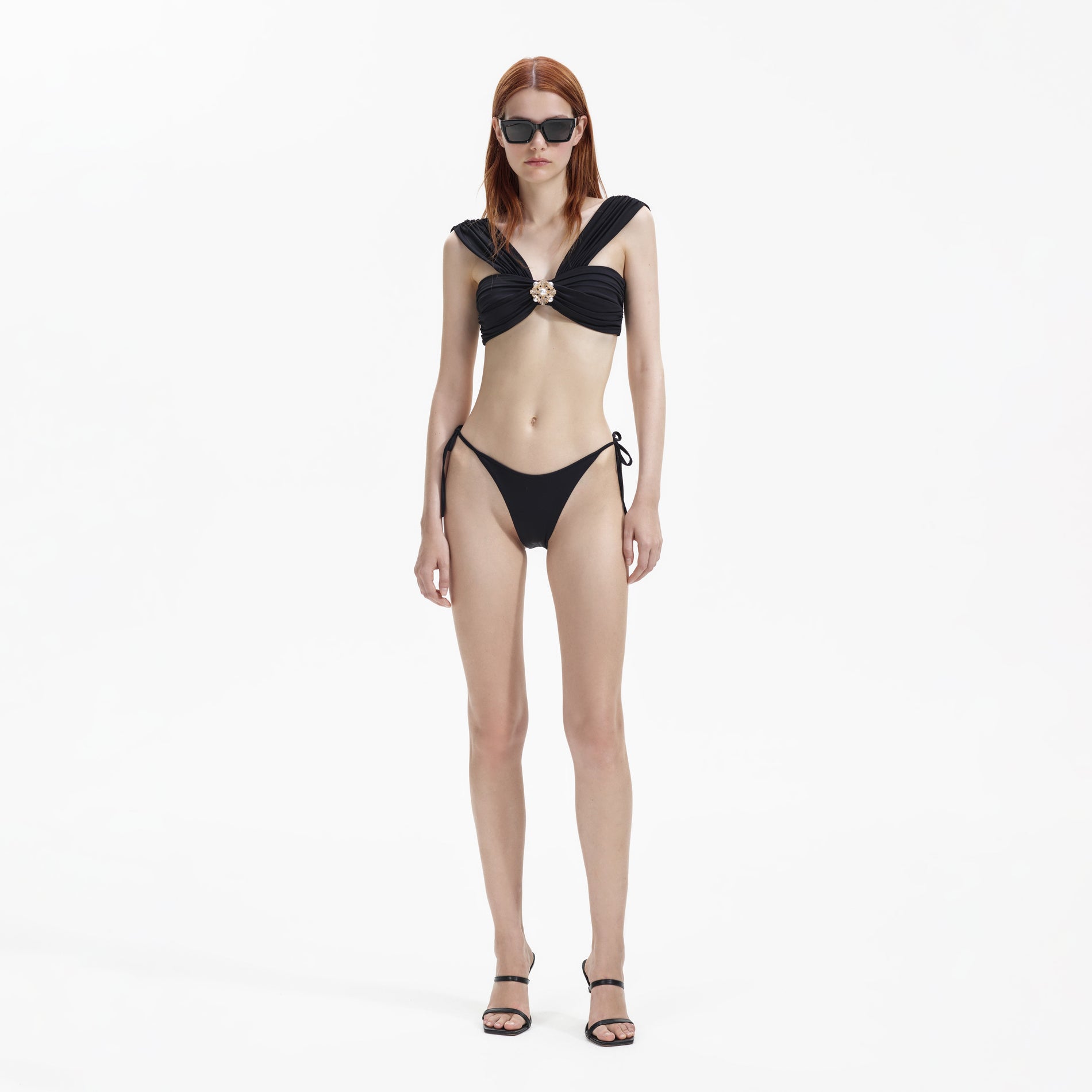 Front view of a woman wearing the Black Tie Side Bikini Brief