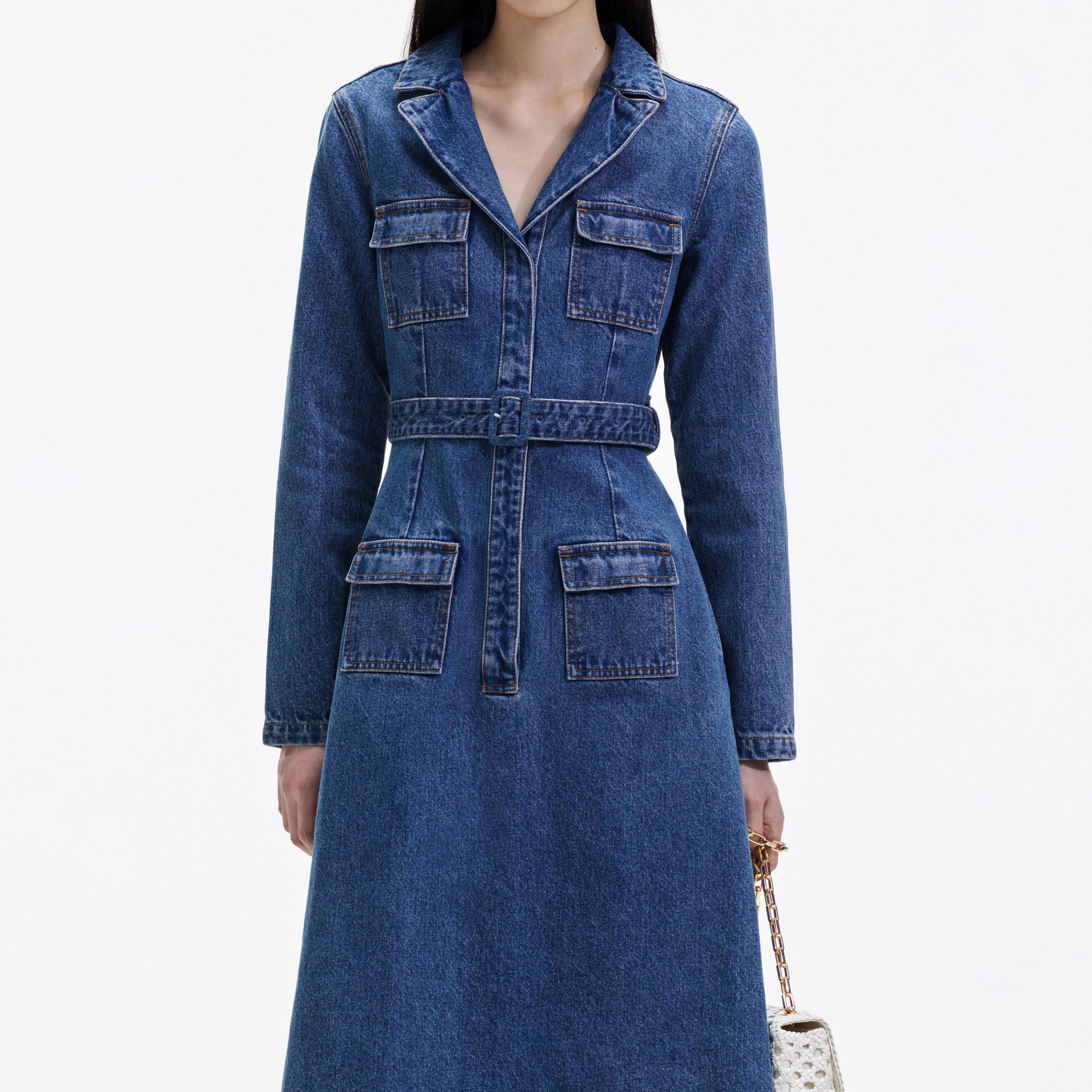 A close up of a woman wearing the Blue Denim Belted Midi Dress