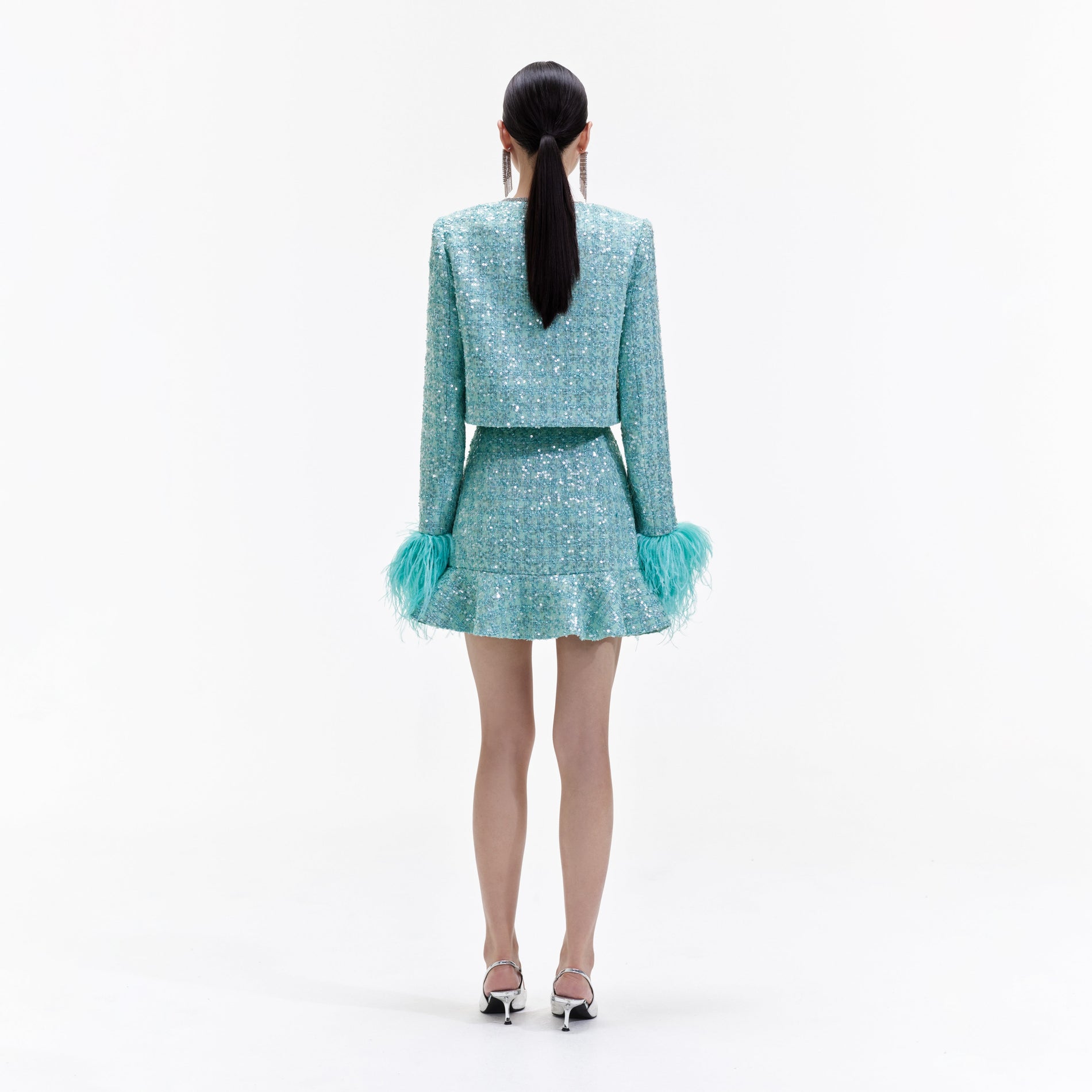 Back view of a woman wearing the Blue Boucle Feather Jacket