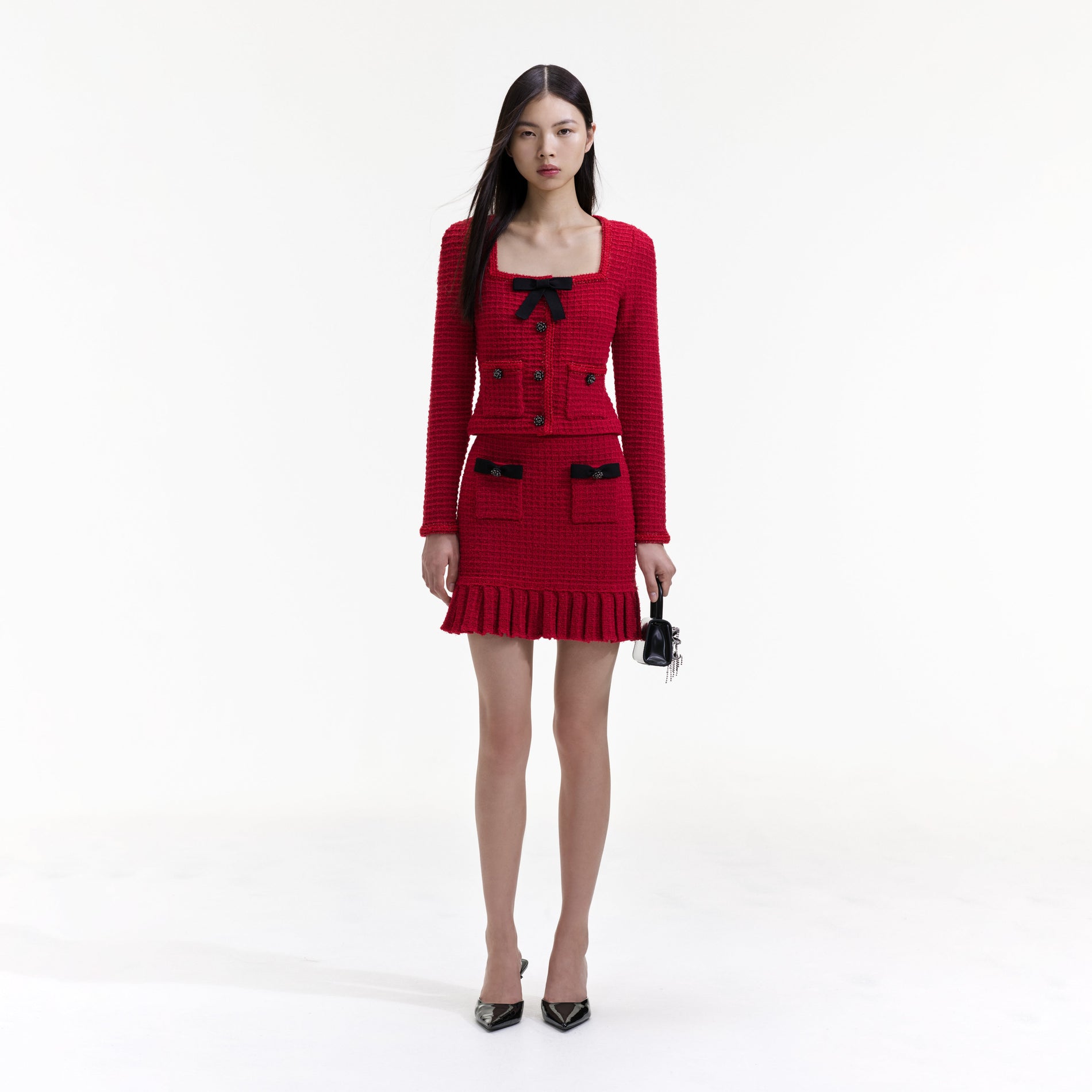 Front view of a woman wearing the Red Knit Bow Top