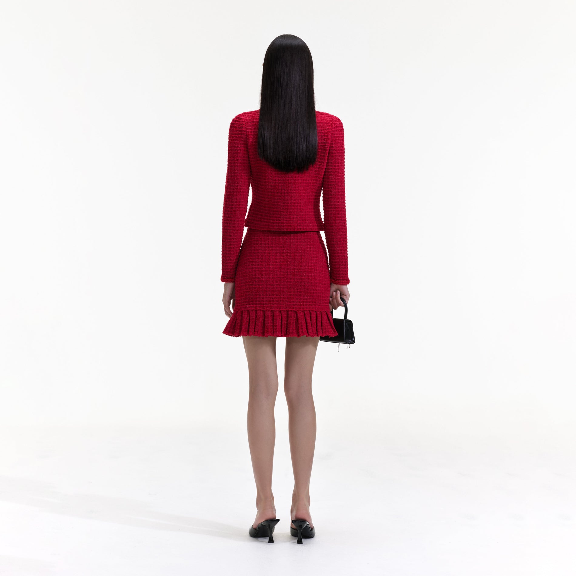 Back view of a woman wearing the Red Knit Bow Top
